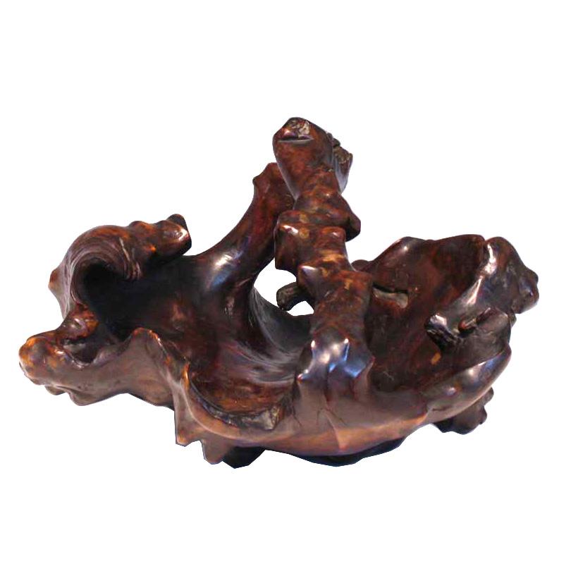 Japanese solid wood fruit and flower display basket, carved from one piece of burl wood in an oval shape with single large overhead handle in a natural form with nodes, grottos and protrusions, finished in a dark brown translucent finish. Minor
