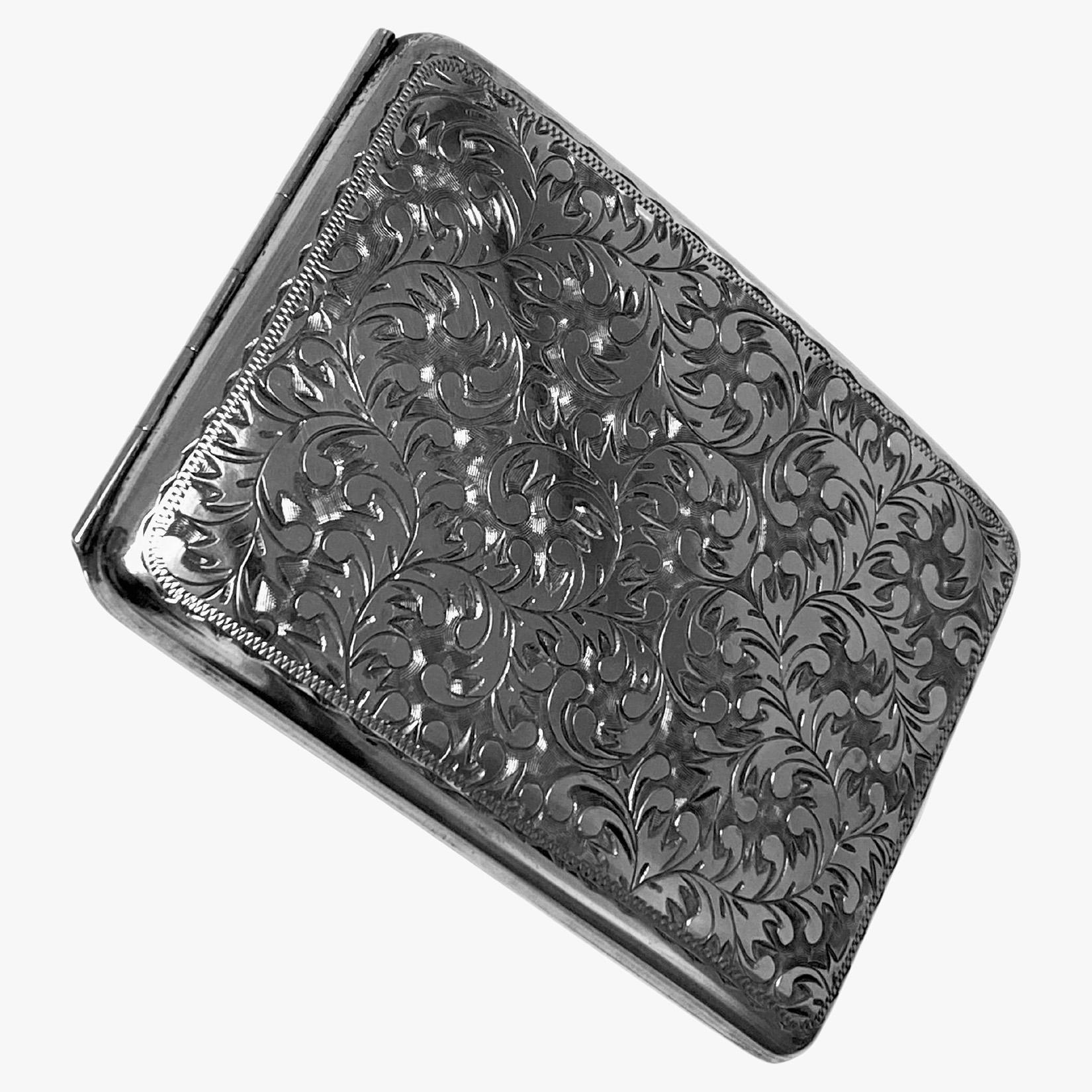 Antique Japanese sterling 950 pure silver cigarette case C.1910. Rectangular concave form, rich engraved foliate decoration on front, the reverse plain with central lozenge shape engraved foliage conforming in design to front. Interior plain with