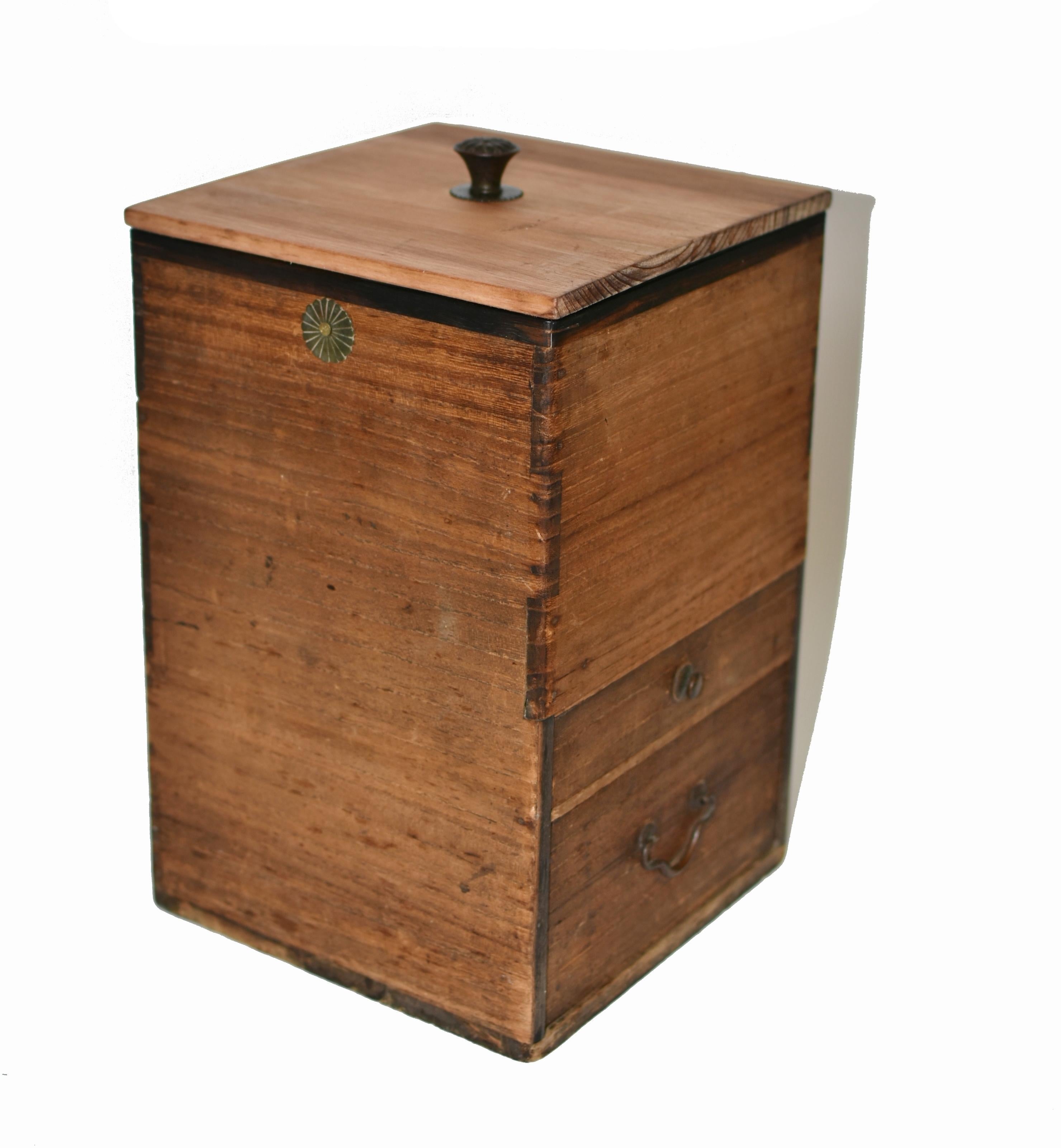 A 19th-century Japanese solid wood storage box in excellent condition, exemplifying fine craftsmanship and timeless design. Featuring two full-depth drawers and a large deep top compartment lined with copper sheets for maximize and insulated