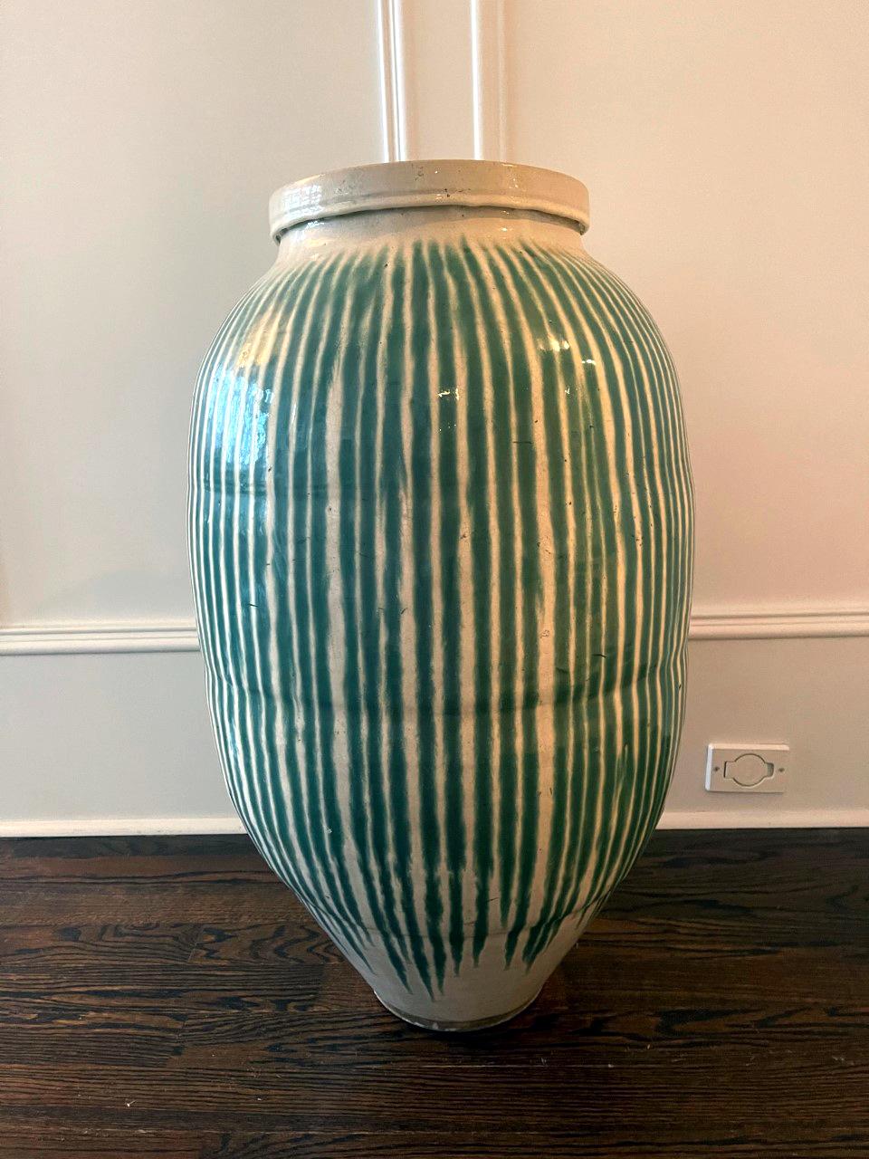 A massive Japanese storage jar (Tsubo) from Meiji Period (1868-1912). Heavily potted with slightly irregular ovoid shape, this type of jars were made to store tea leaves in the shop. Due to the hand-coiled construction process, these jars tend to be