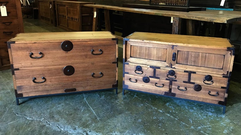 This listing is for two Japanese tansus with custom made metal stands. The piece on the left has two drawers and the piece on the right has a pair of sliding doors and five smaller drawers. Both pieces are in excellent condition. Small tarsus make