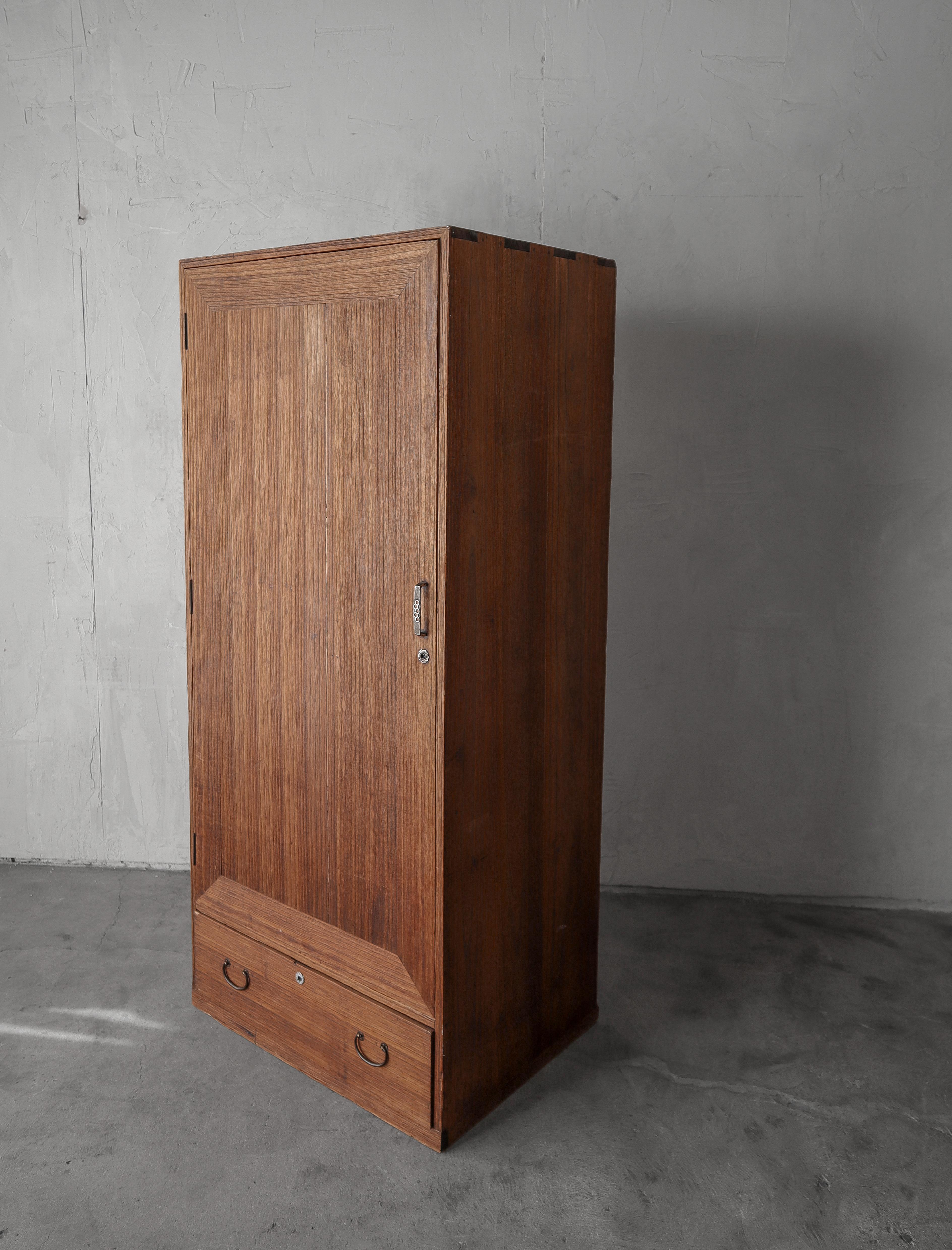 A beautiful example of an antique Japanese kimono cabinet.  This piece is beautiful with countless decades of character from age and use.  Crafted of teak wood with the most unique infinite rectangle pattern on the doors combined with the detailed