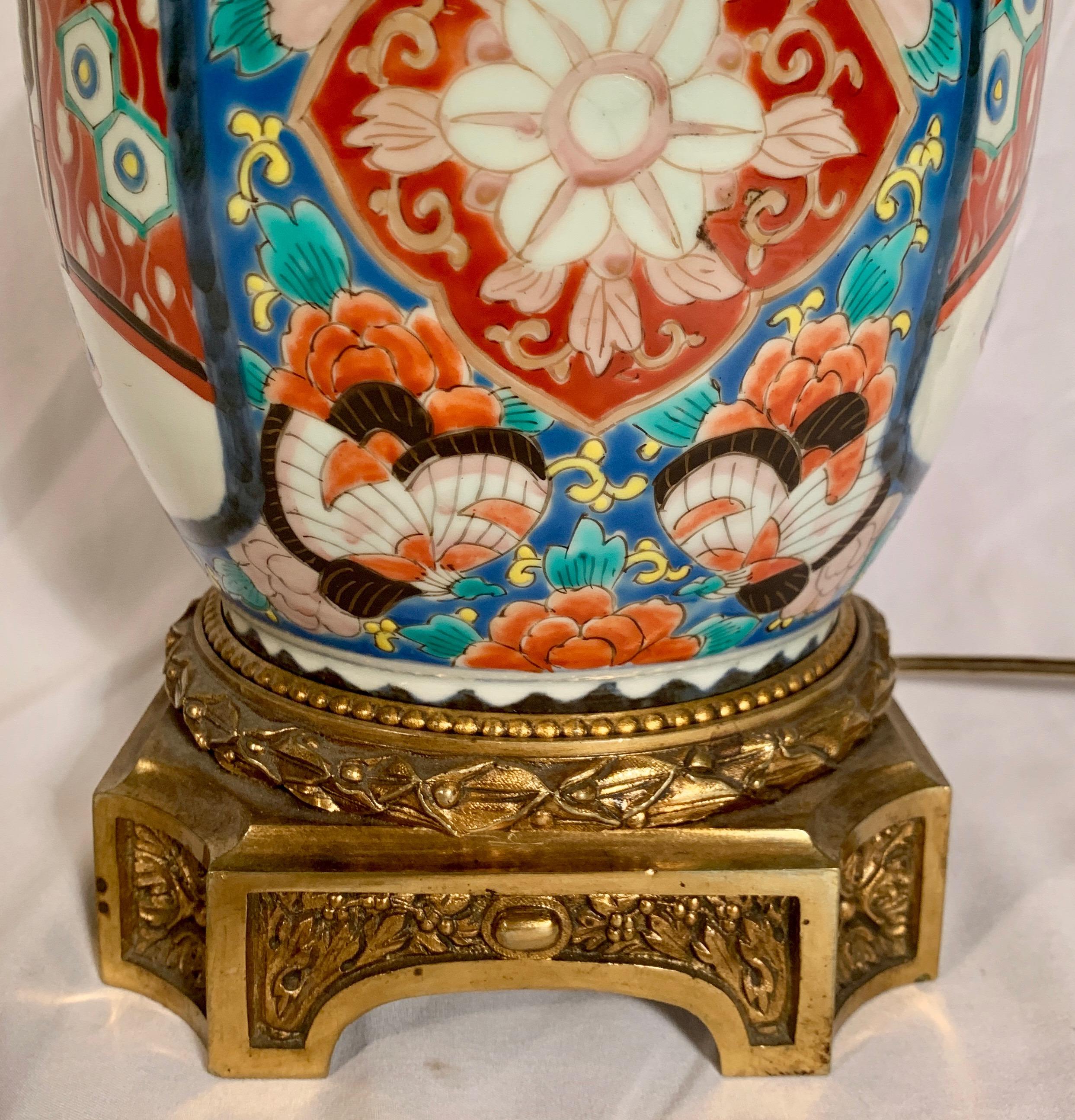 This lovely Japanese urn was converted to a lamp. The colors on the porcelain urn remain strong and the design sharp. 
