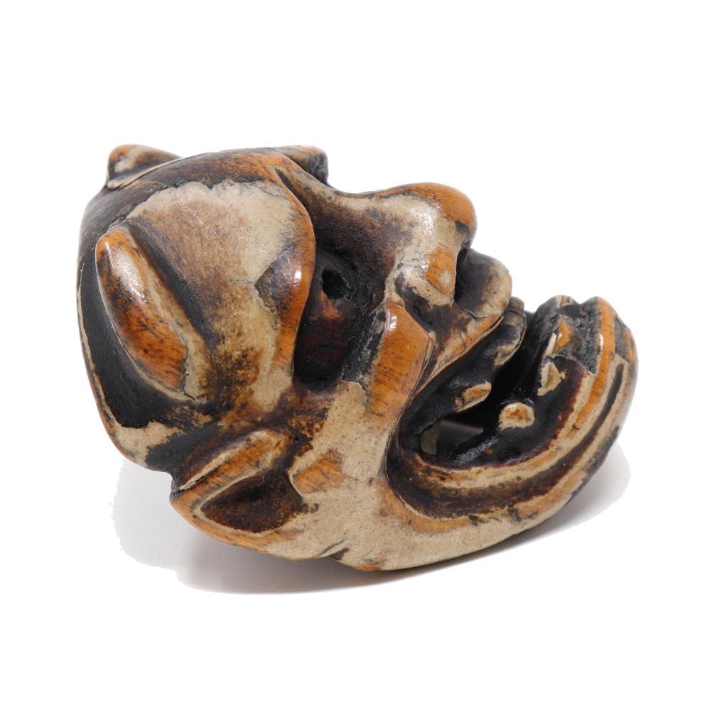 Antique Japanese Wood Miniature Mask Netsuke, an unsigned work depicting Hannya, the female horned demon popular in Noh performance plays, a solid hardwood piece carved in high relief as a miniature mask having pierced pupils and an open mouth