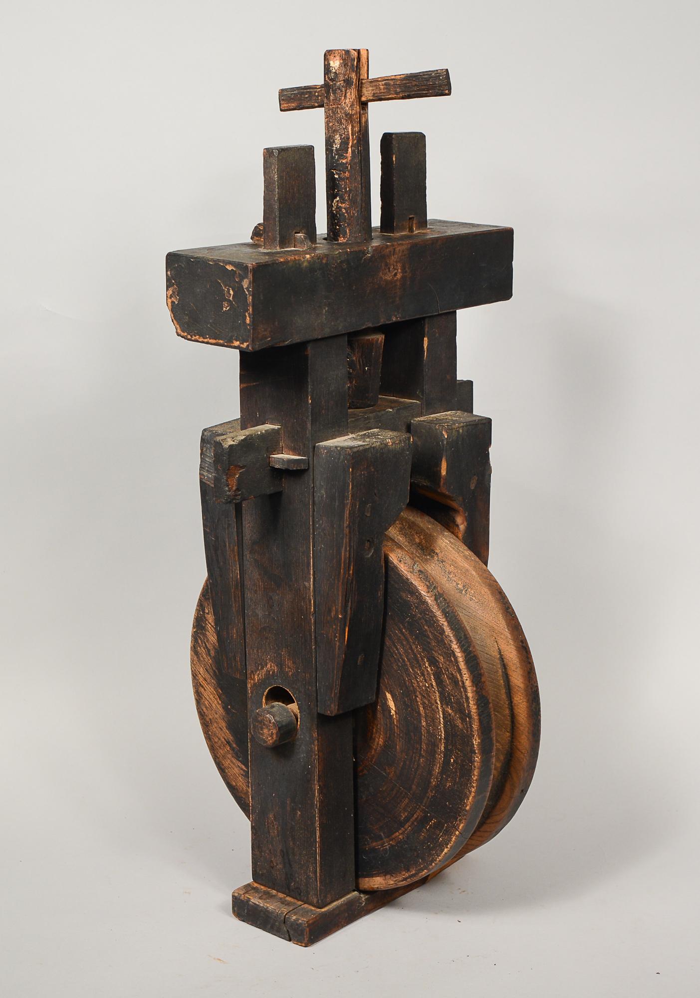 Antique wooden Japanese pulley from the 19th century. These were often used in wells to retrieve pails of water. This shows lots of authentic heavy wear from likely decades of use. The base and the four wood blocks on the uprights were added at some