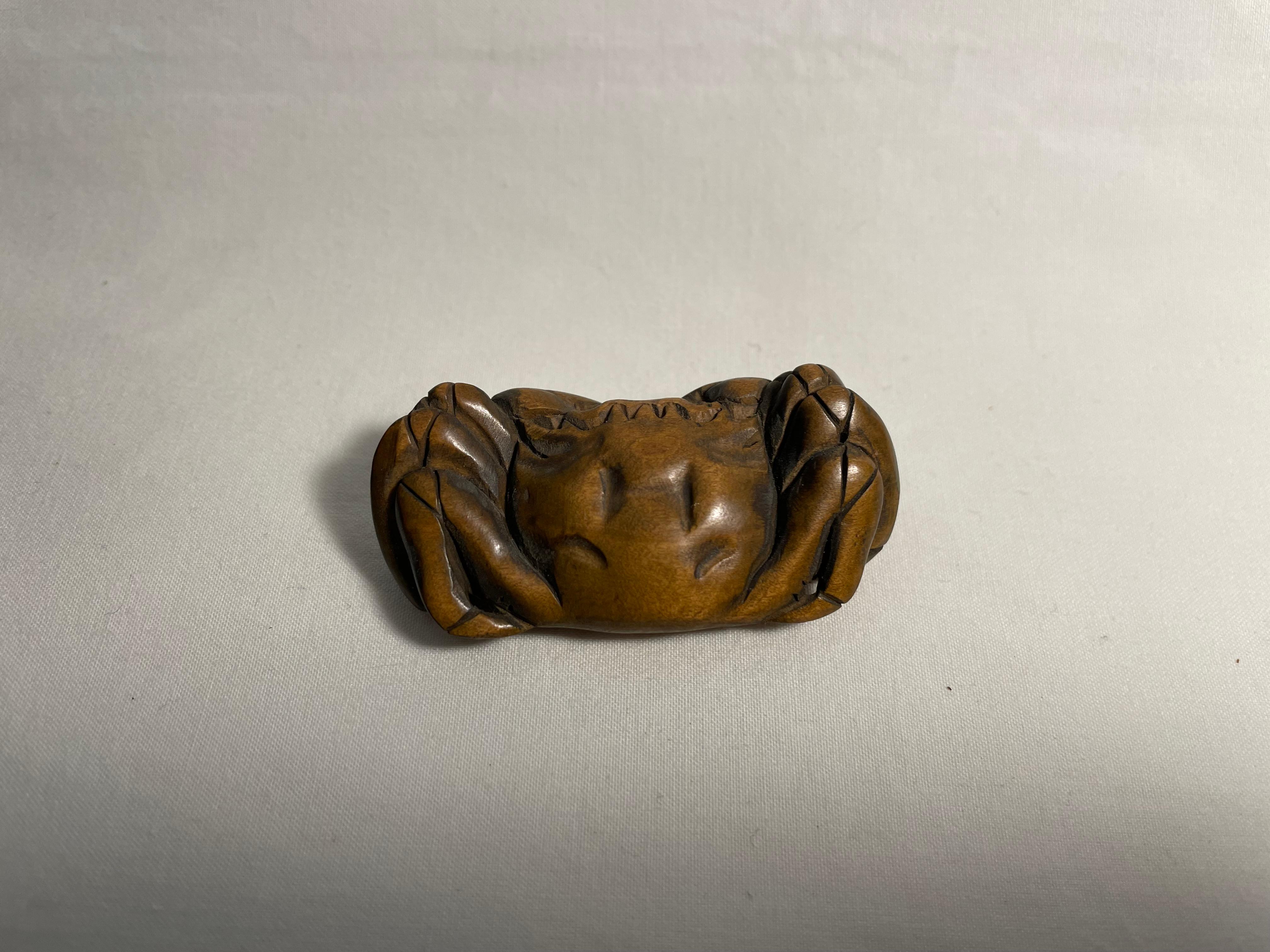 This is an antique netsuke made in Japan around meiji period 1900s.
This netsuke was made by a netsuke artist 'Gyokuseki' (you can see his signature on the bottom of this crab.)

Netsuke is a miniature sculpture, originating in 17th century