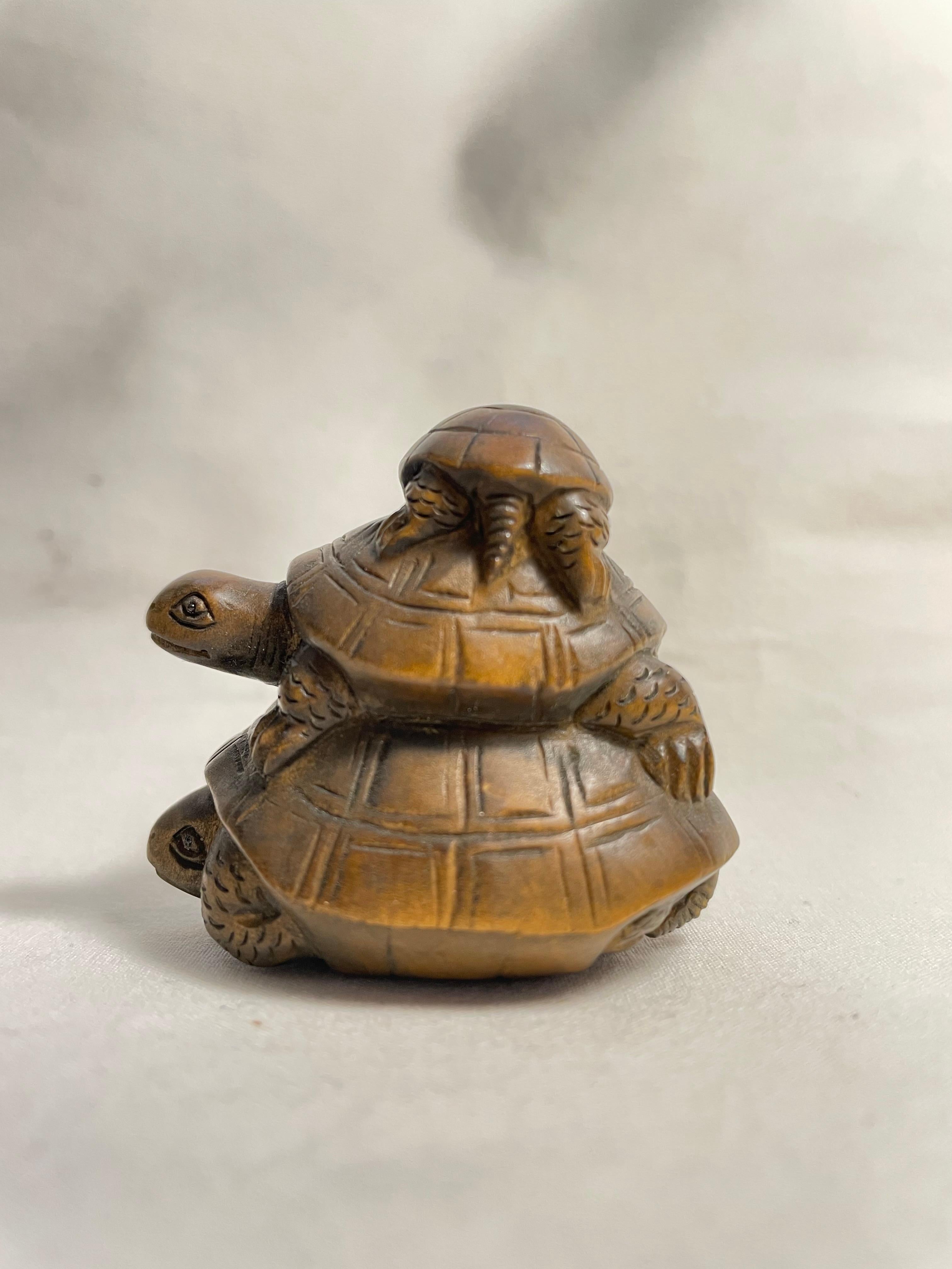 This is an antique netsuke made in Japan around meiji period 1900s.

Netsuke is a miniature sculpture, originating in 17th century Japan.
Initially a simply-carved button fastener on the cords of an inro box, netsuke later developed into ornately