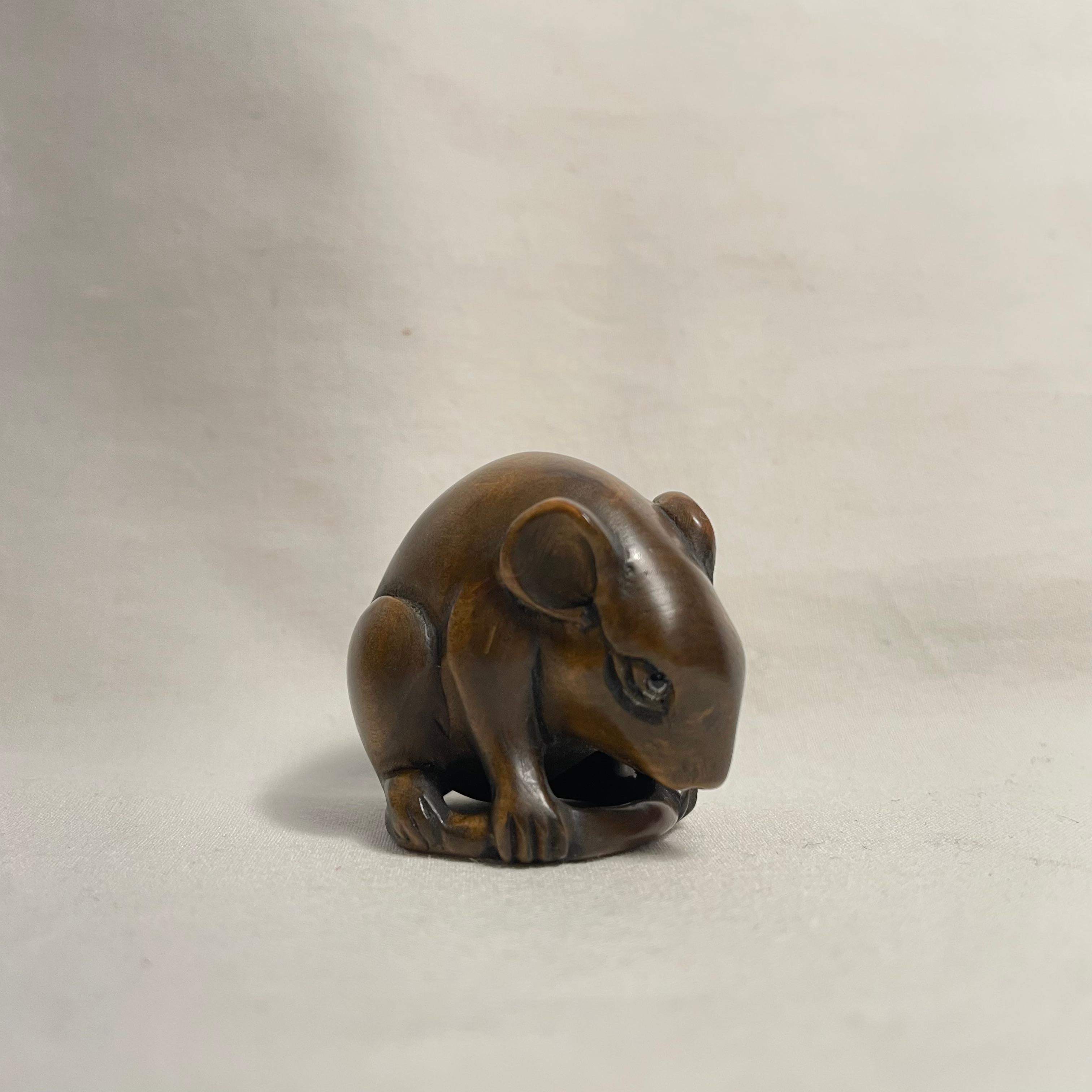 This is an antique wooden netsuke made in Japan around Taisho period 1920s.

Netsuke is a miniature sculpture, originating in 17th century Japan.
Initially a simply-carved button fastener on the cords of an inro box, netsuke later developed into