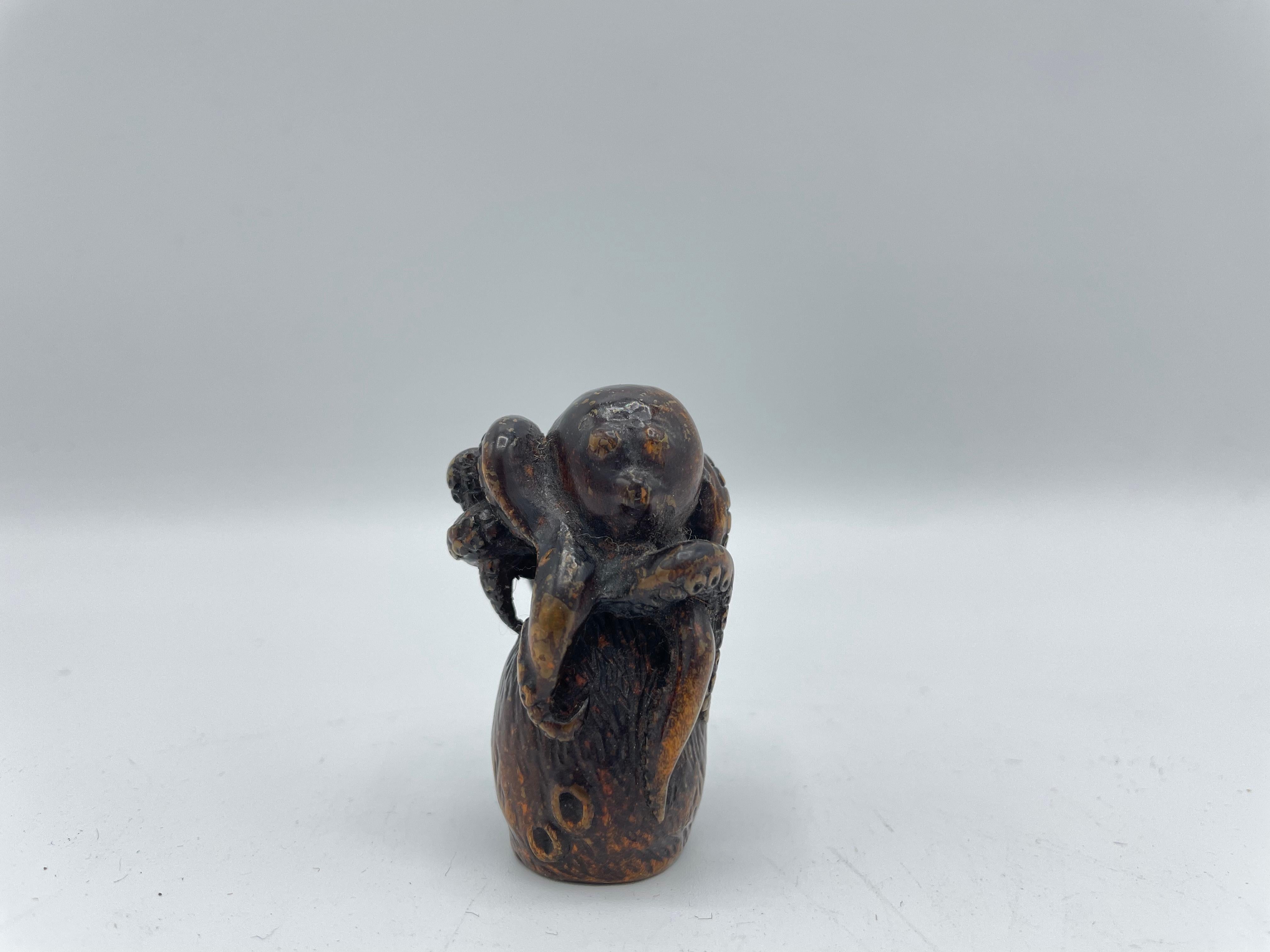 This is an antique netsuke made in Japan around Edo period 1800s.
Netsuke is a miniature sculpture, originating in 17th century Japan.
Initially a simply-carved button fastener on the cords of an inro box, netsuke later developed into ornately