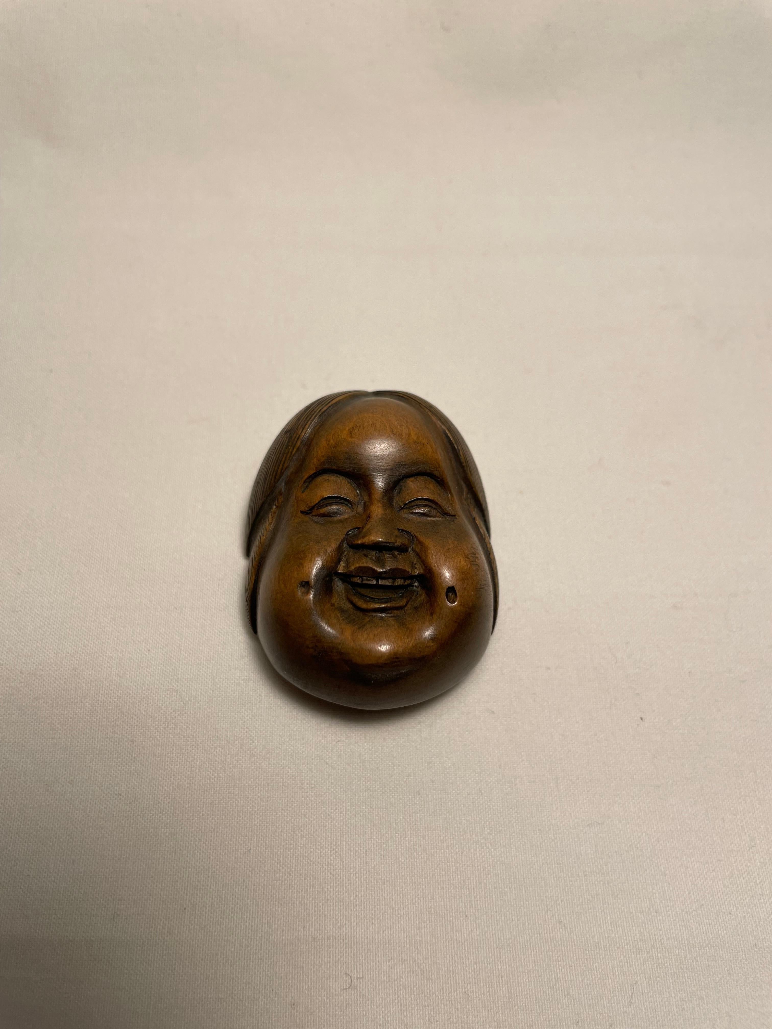 This is an antique netsuke made in Japan around Showa period 1950s.

Netsuke is a miniature sculpture, originating in 17th century Japan.
Initially a simply-carved button fastener on the cords of an inro box, netsuke later developed into ornately