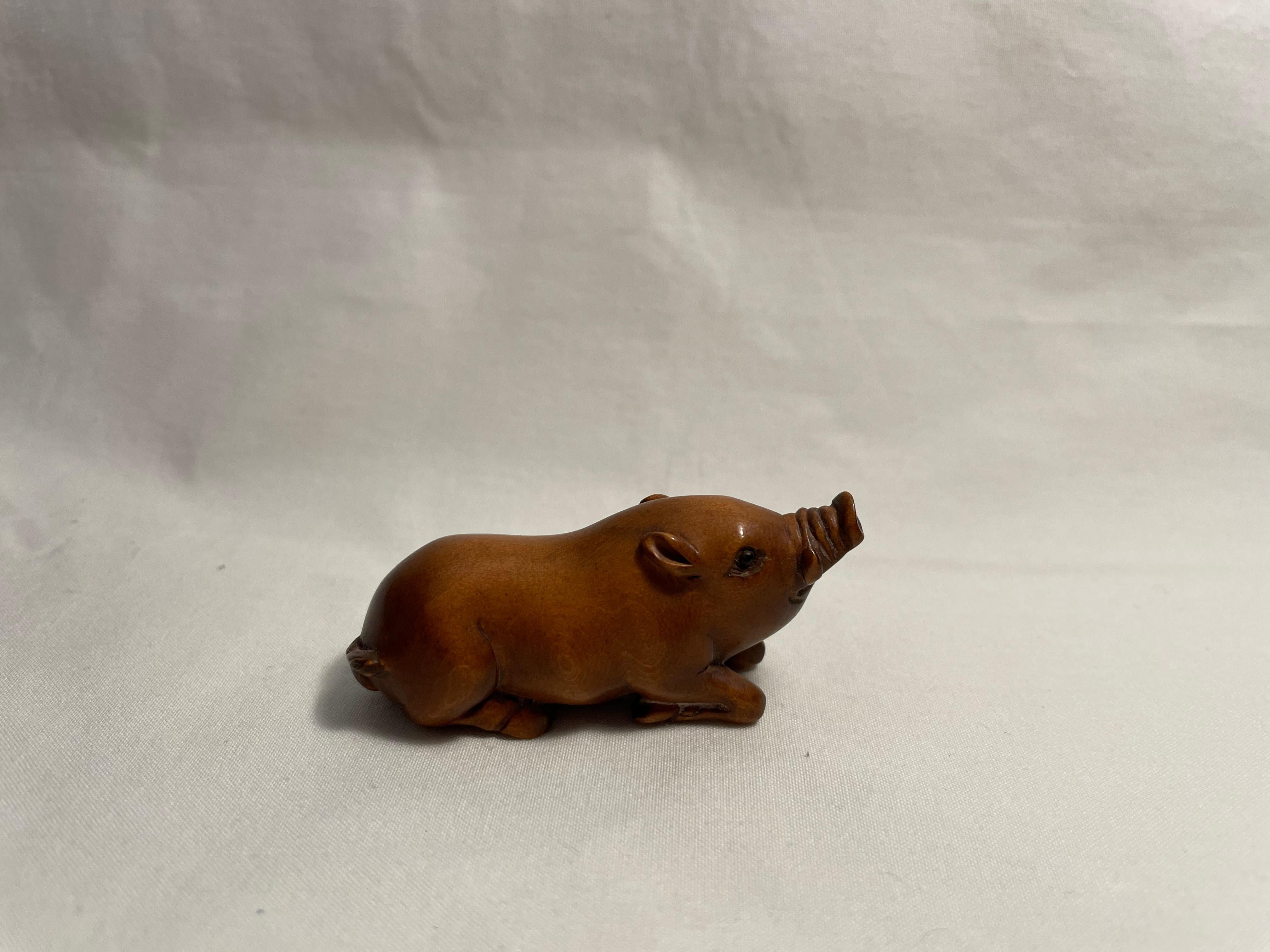 This is an antique netsuke made in Japan around Taisho period 1920s.
This netsuke was made by a netsuke artist 'Gyokuseki' (you can find his signature on the stomach of this pig netsuke.)
Netsuke is a miniature sculpture, originating in 17th