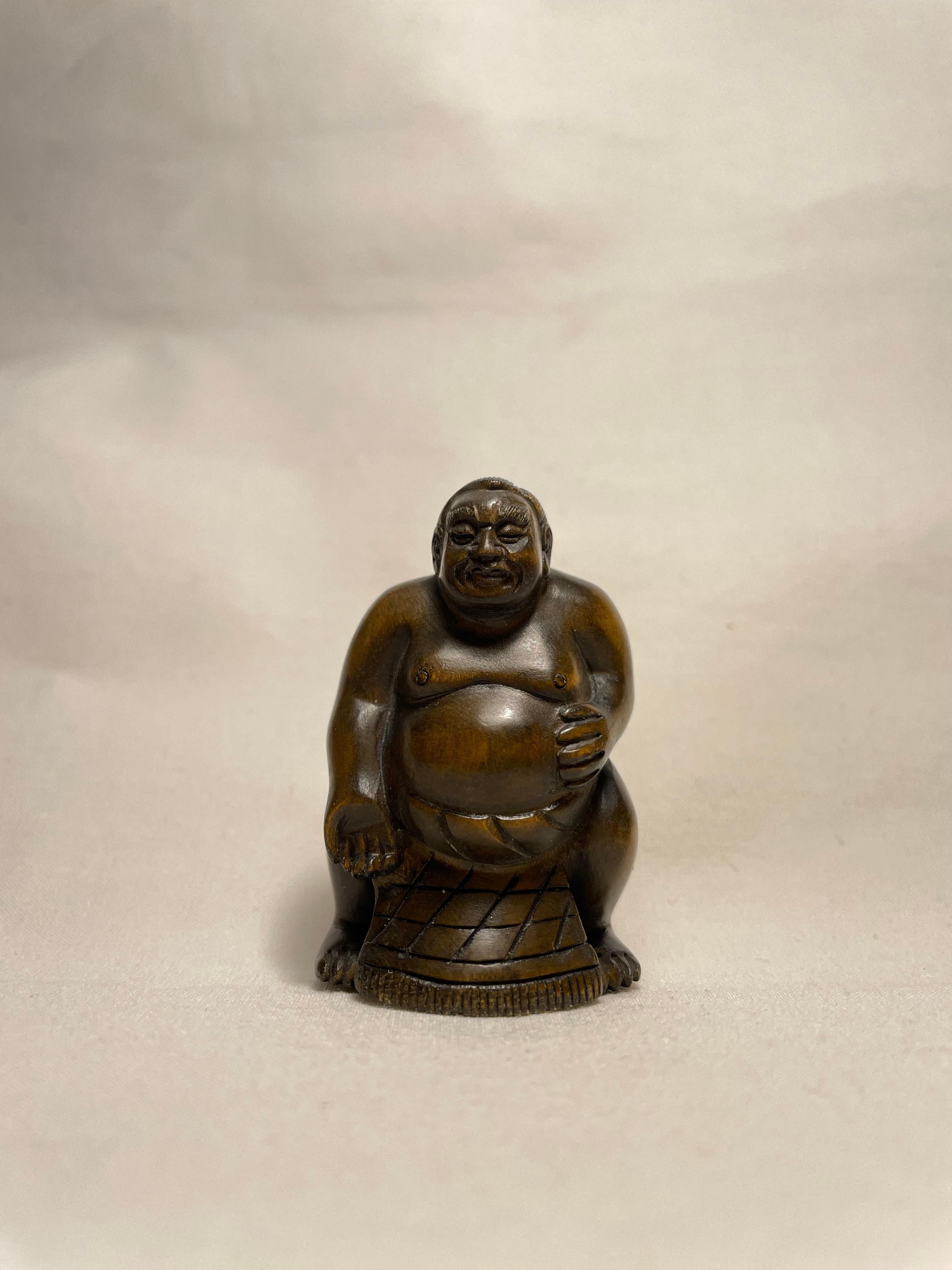 This is an antique netsuke made in Japan around Taisho period 1920s.

Netsuke is a miniature sculpture, originating in 17th century Japan.
Initially a simply-carved button fastener on the cords of an inro box, netsuke later developed into ornately