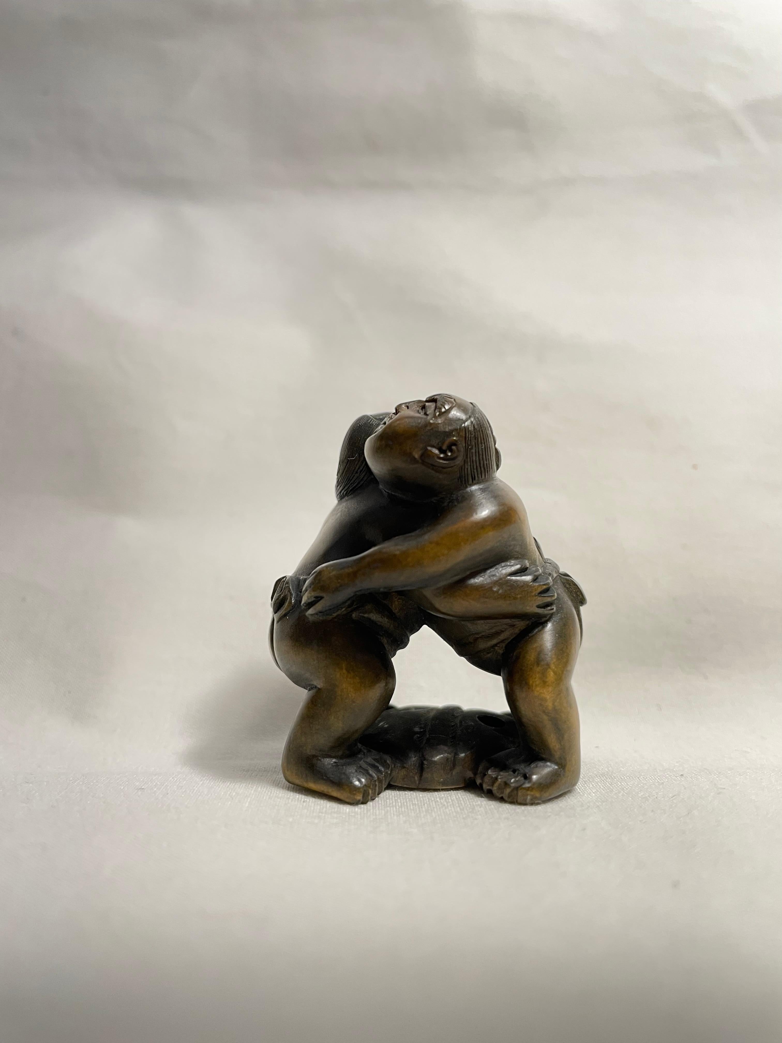 This is an antique netsuke made in Japan around Showa period 1920s.
This netsuke was made by a netsuke artist 'Matsuyama' (you can find his signature on the bottom of this netsuke.)

Netsuke is a miniature sculpture, originating in 17th century