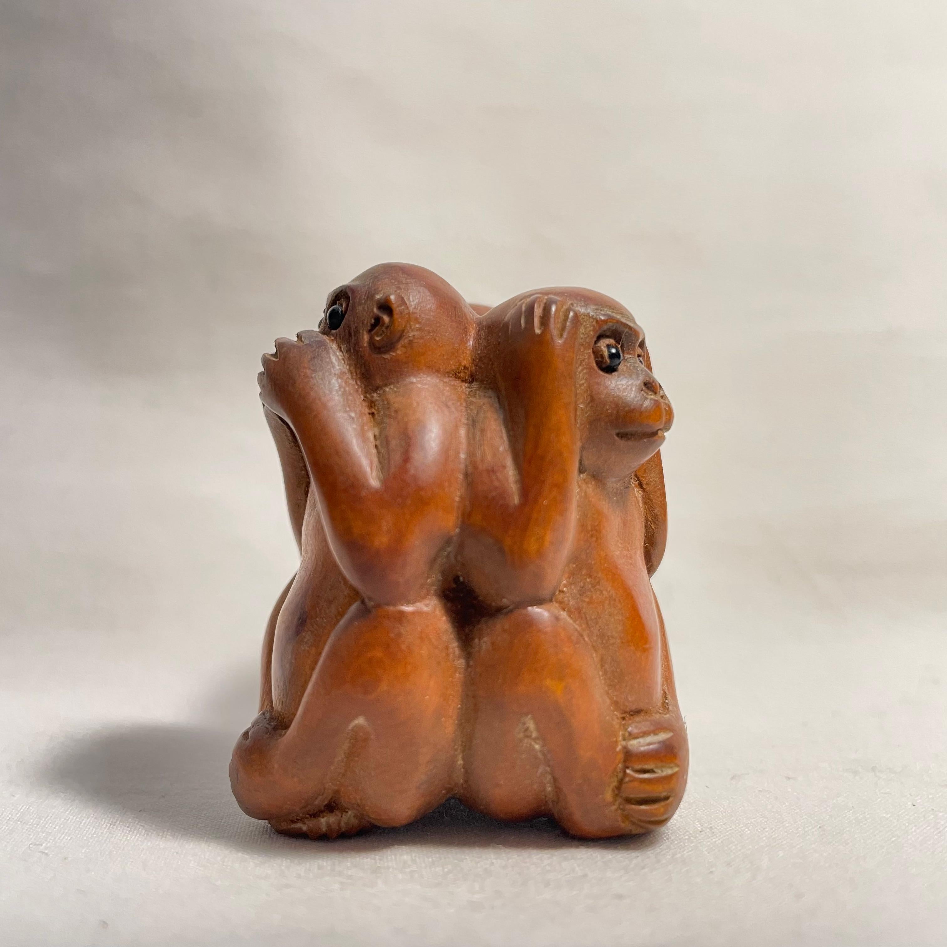 This is an antique wooden netsuke made in Japan around Taisho period 1920s.

Netsuke is a miniature sculpture, originating in 17th century Japan.
Initially a simply-carved button fastener on the cords of an inro box, netsuke later developed into