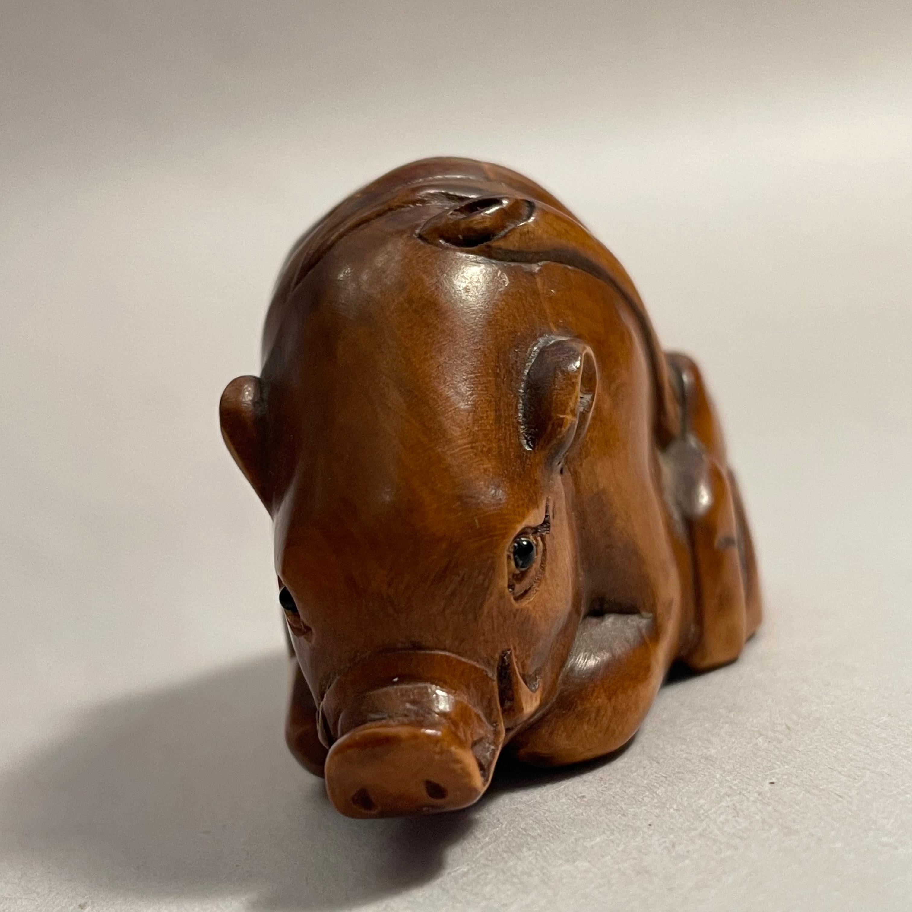 This is an antique wooden netsuke made in Japan around Showa period 1950s.
The signature is written on the back side 'Tomotada'.

Netsuke is a miniature sculpture, originating in 17th century Japan.
Initially a simply-carved button fastener on the