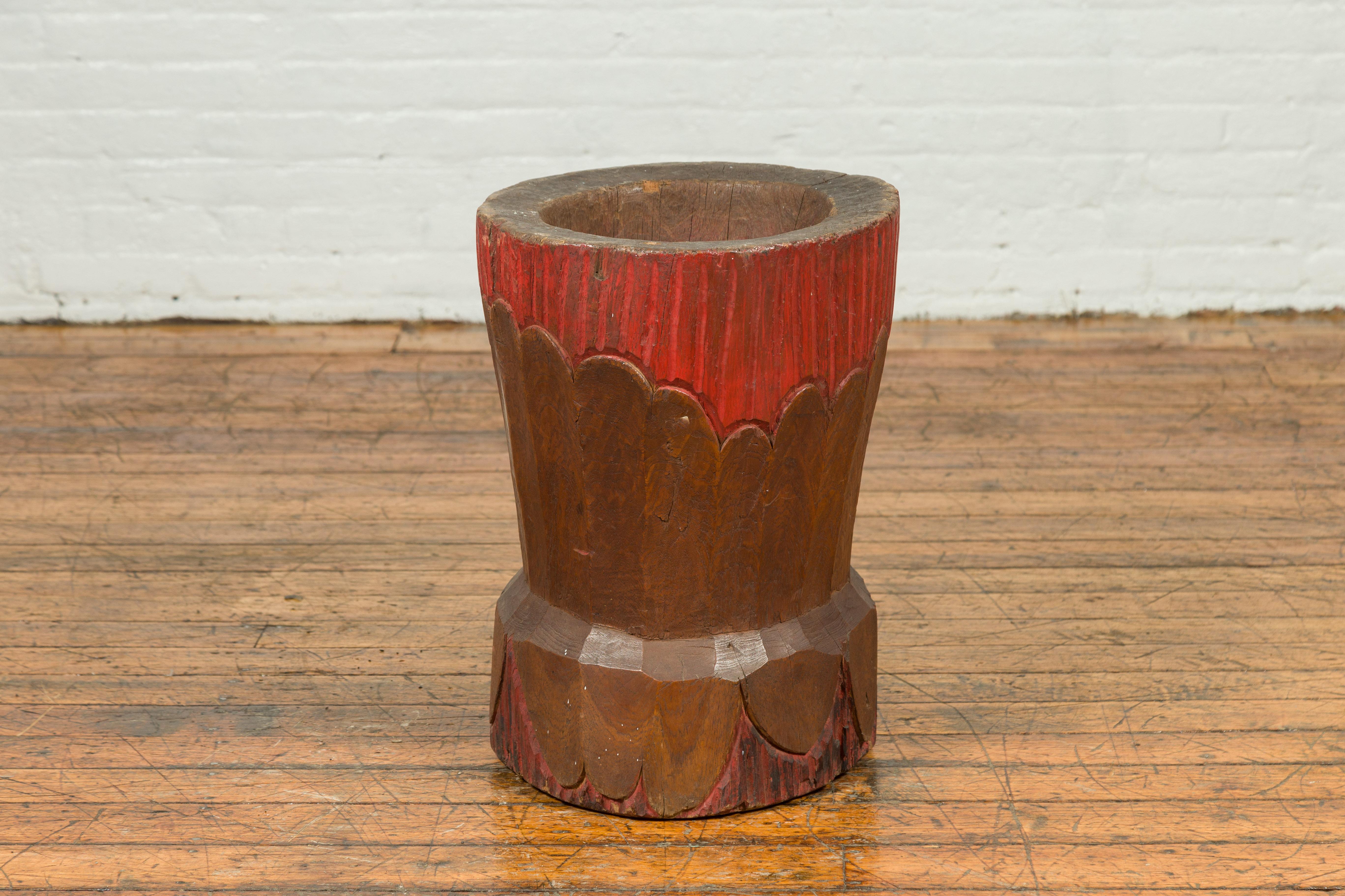 An antique Japanese wooden planter with floral design and red patina. Crafted in Japan, this wooden planter charms us with its rustic appearance and contrasting colors. Showcasing a design resembling flower petals, this Japanese planter will bring a