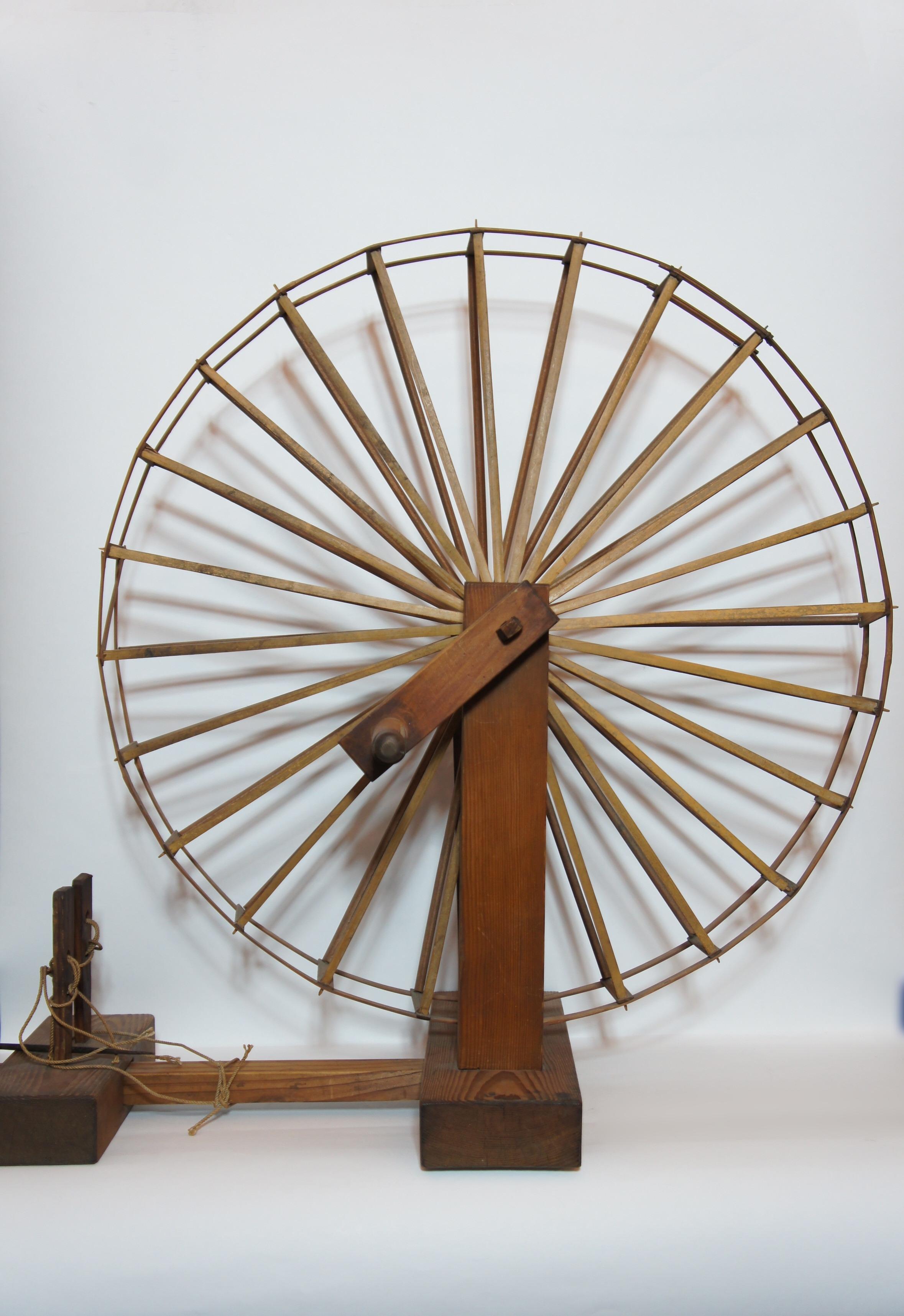 The spinning wheels are invented in Persia around the 13th century and introduced to India. It is thought to have been introduced to Japan in the Edo period. This spinning wheel is made in 1960s (mid-Showa era) and made of wood.