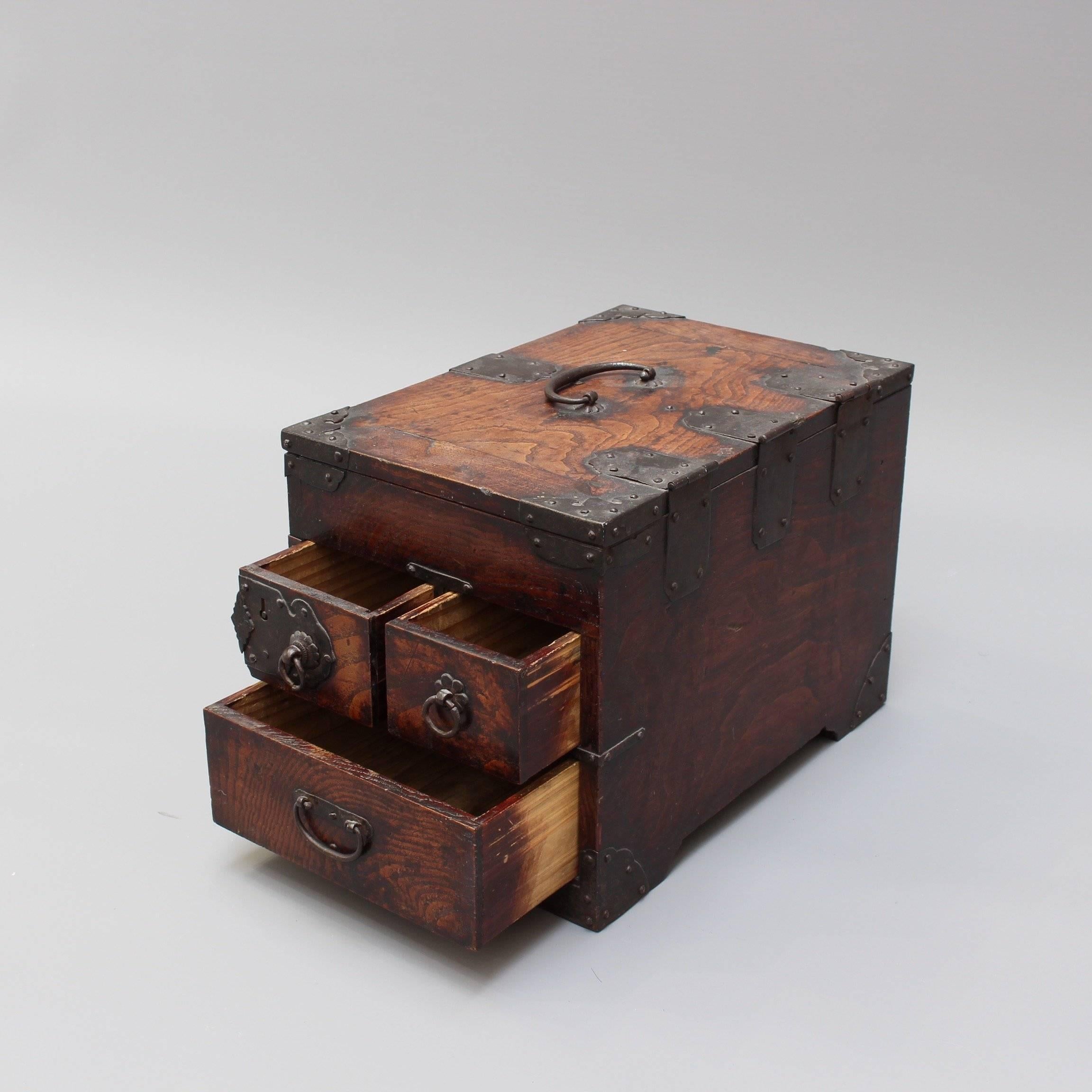 Antique Japanese wooden writing box with decorative hardware (Meiji Era). This calligraphy box has sumptuous wood with characterful painted black hardware. The lid is hinged and has a carrying handle. The box also has three side drawers - one with