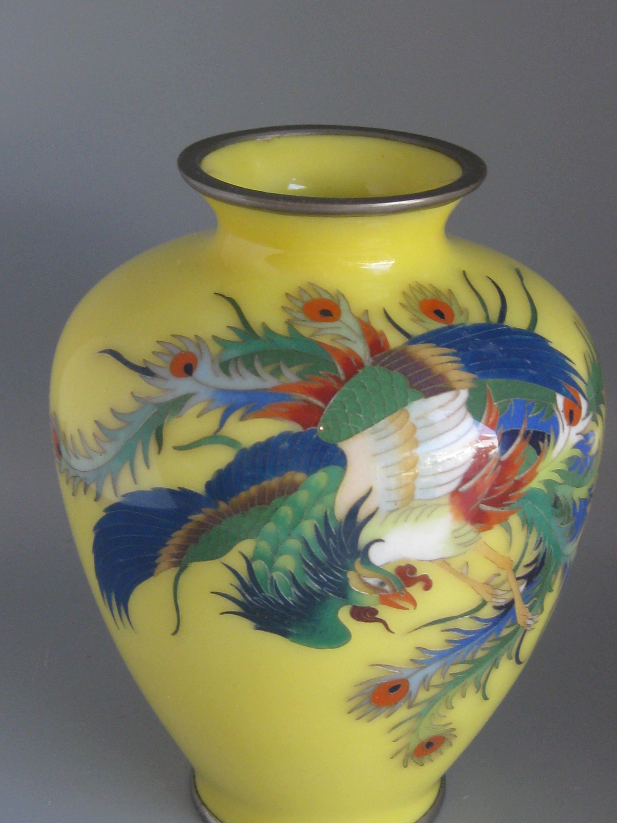 Beautiful antique Japanese cloisonné enamel vase featuring a Hoo-oo bird and dating from the Meiji era. The vase features colorful cloisonné decorations and details. High quality and made well. In very nice original condition for its age. No chips,