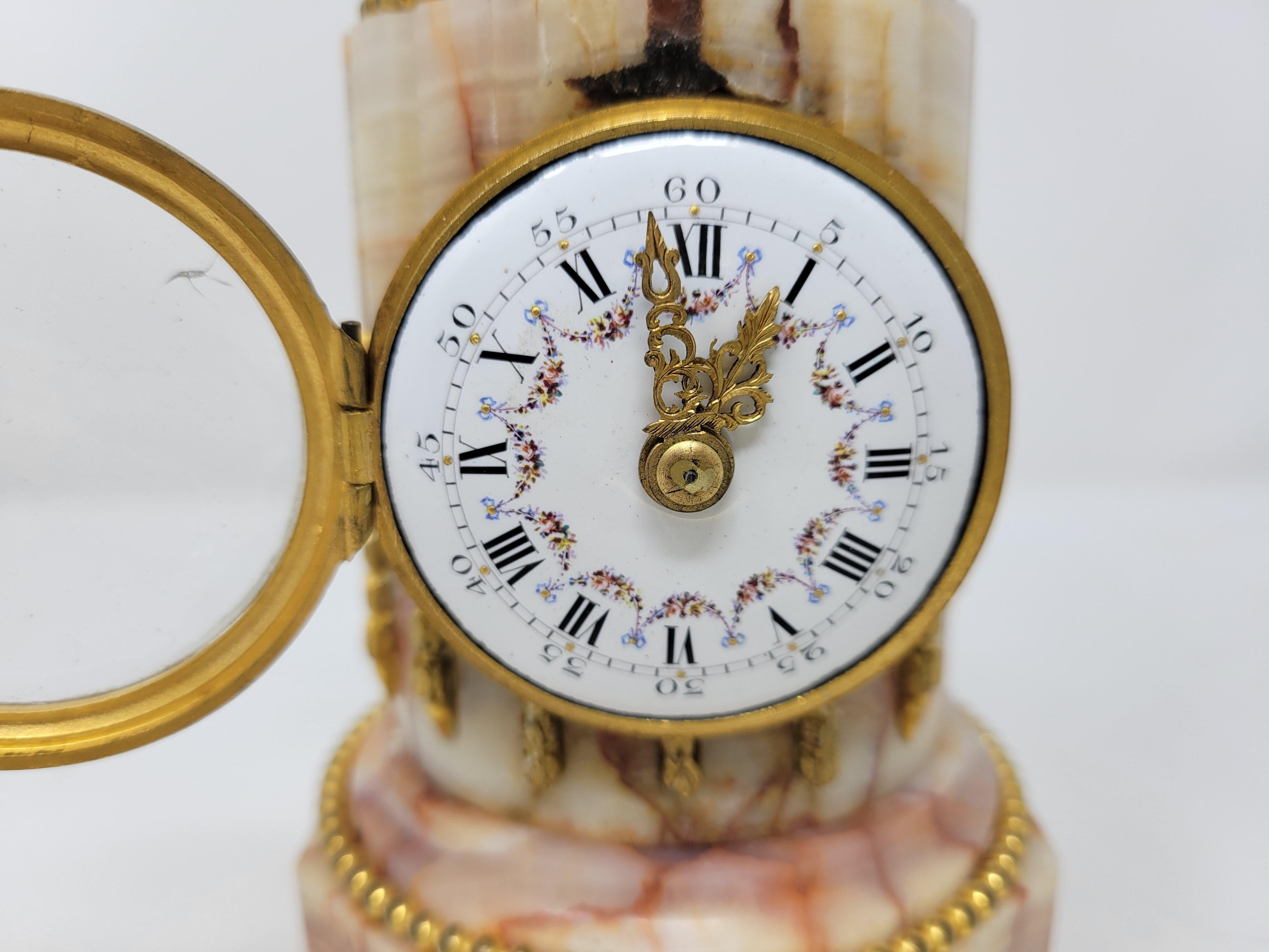A very handsome little clock. The patterns in the pale rose/coral quartz are pleasing.