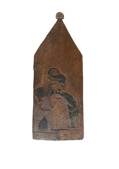 Panel de madera antiguo de Java, tallado a mano al estilo «wayang», que representa una figura de marioneta de sombras