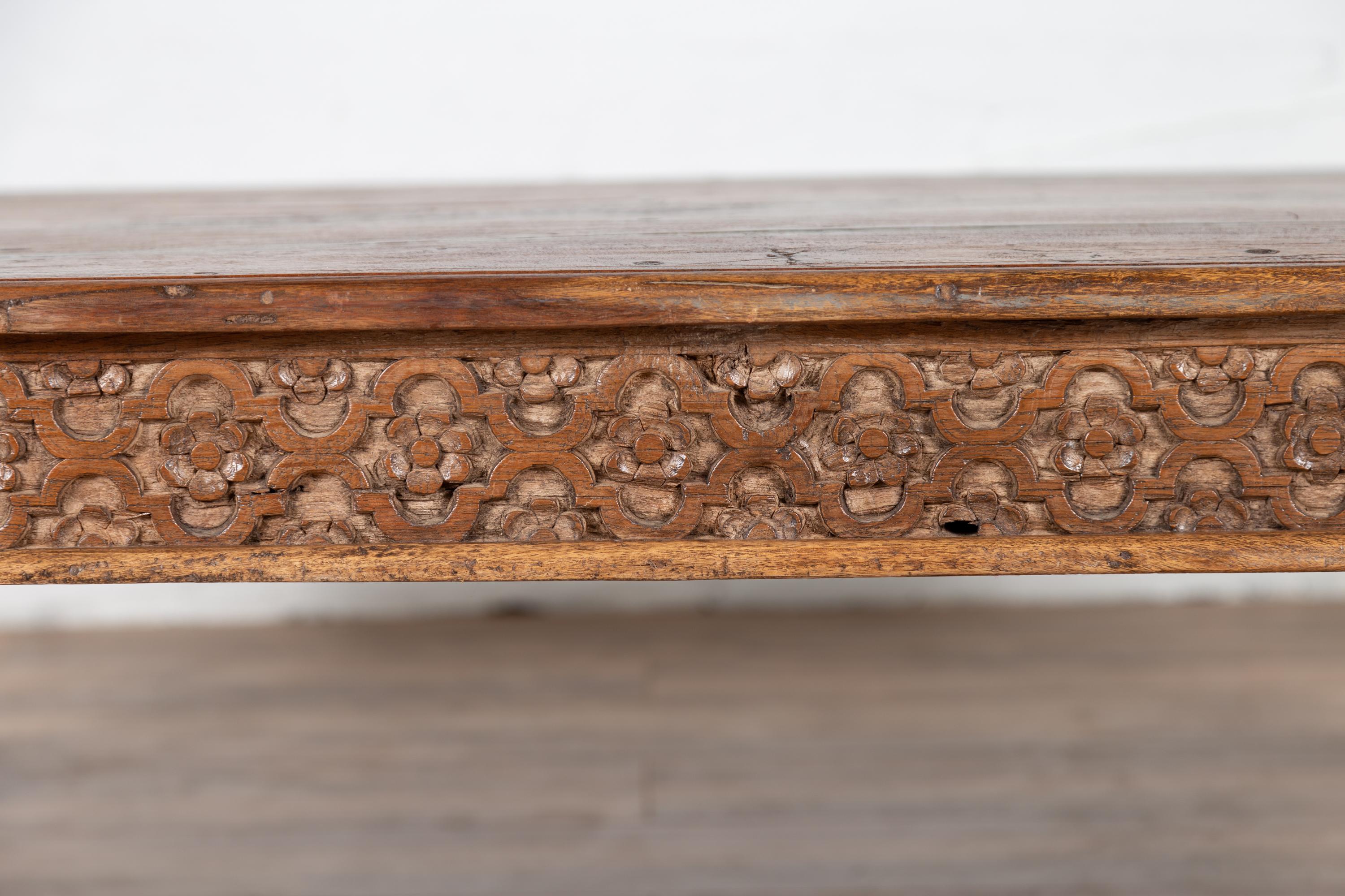 20th Century Antique Javanese Teak Wood Coffee Table with Hand Carved Floral Themed Apron