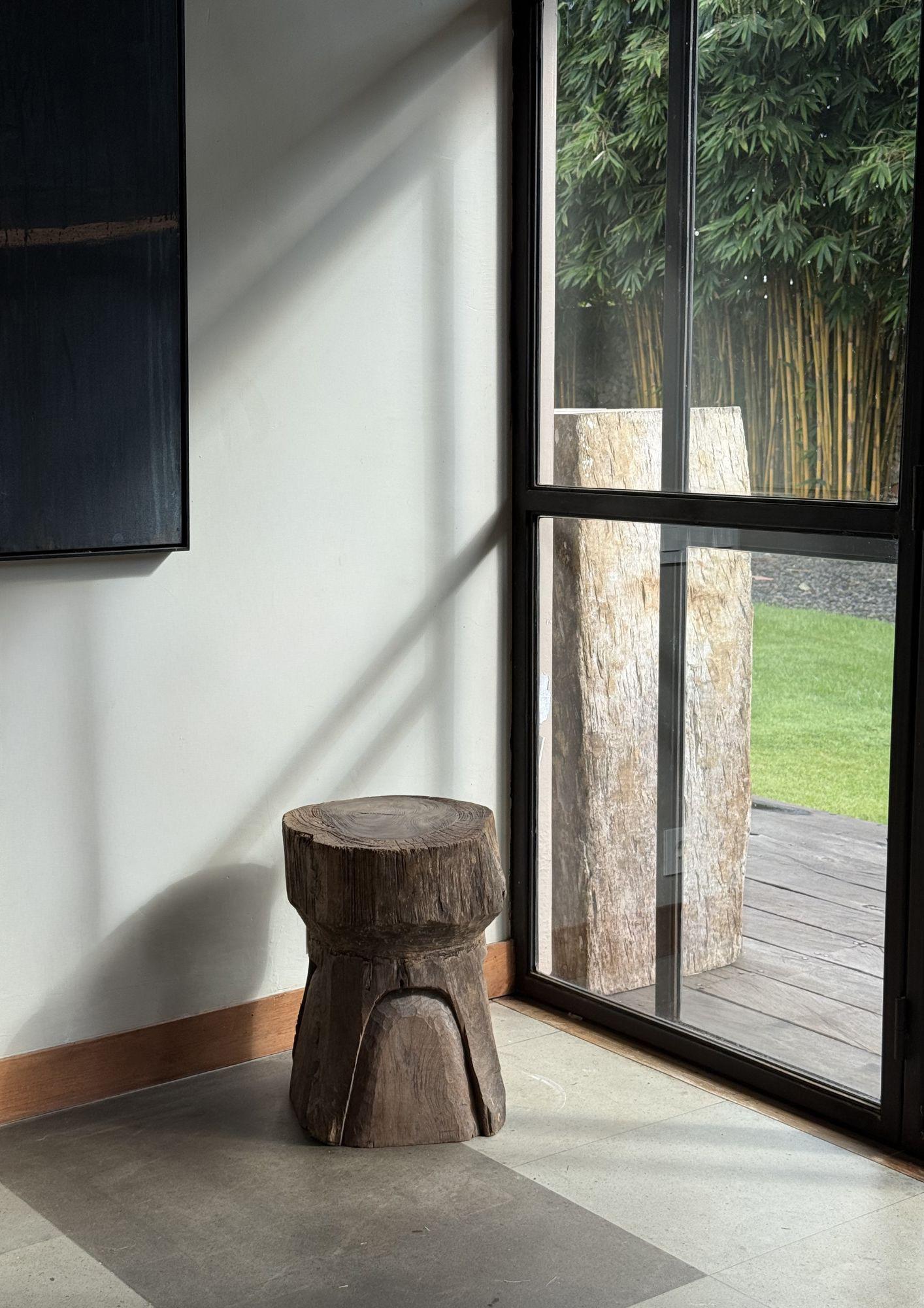 This versatile antique piece, handcrafted from solid teak wood in Java, Indonesia, functions beautifully as both a stool and a side table. Its compact, sturdy form is enriched by a wonderful age-related patina, highlighting decades of natural wear