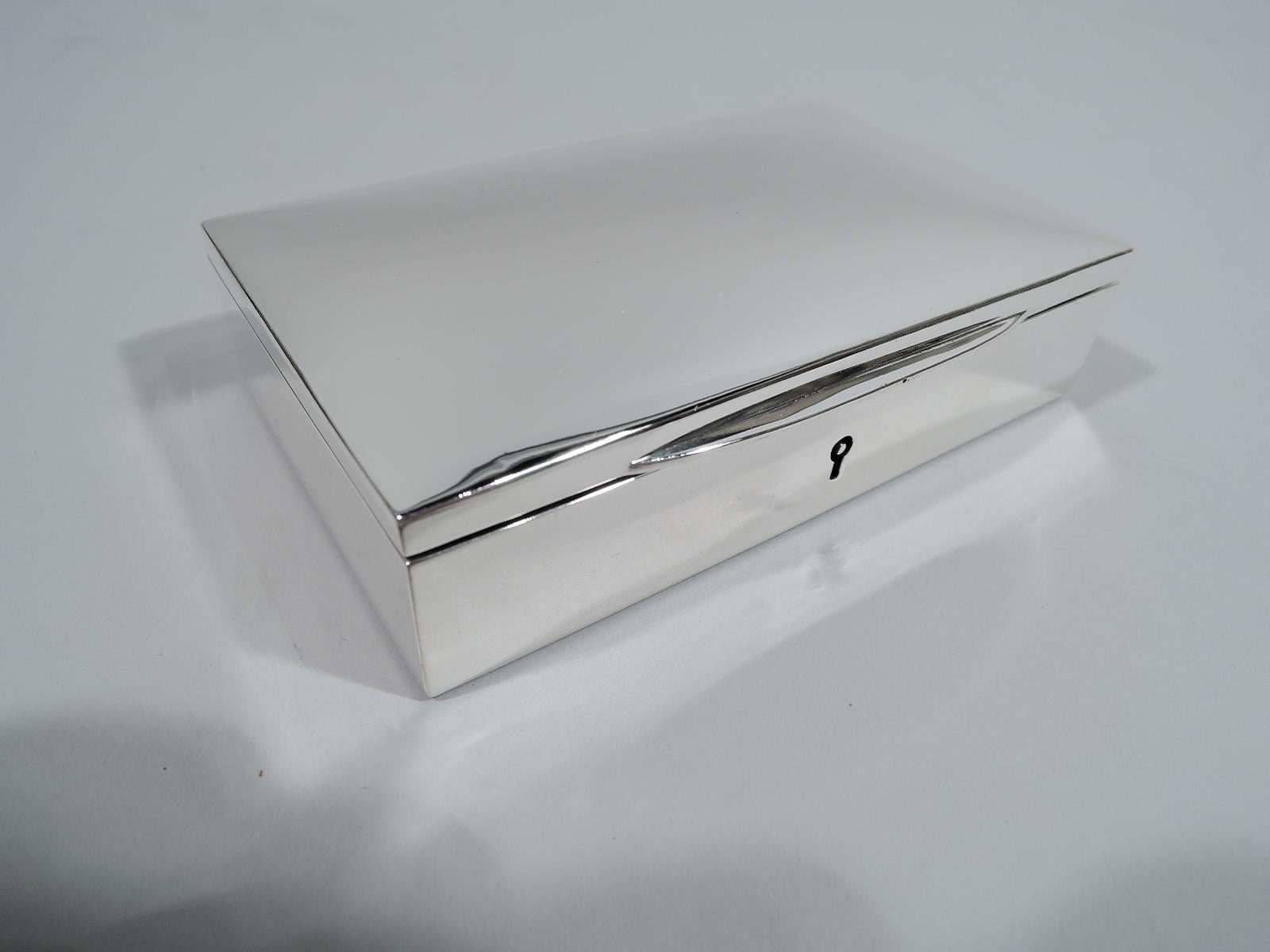 Modern sterling silver box, ca 1920. Retailed by JE Caldwell in Philadelphia. Rectangular with straight sides. Cover hinged and gently curved with tapering tab. A handy and stylish receptacle for desk detritus. Fully marked including New York