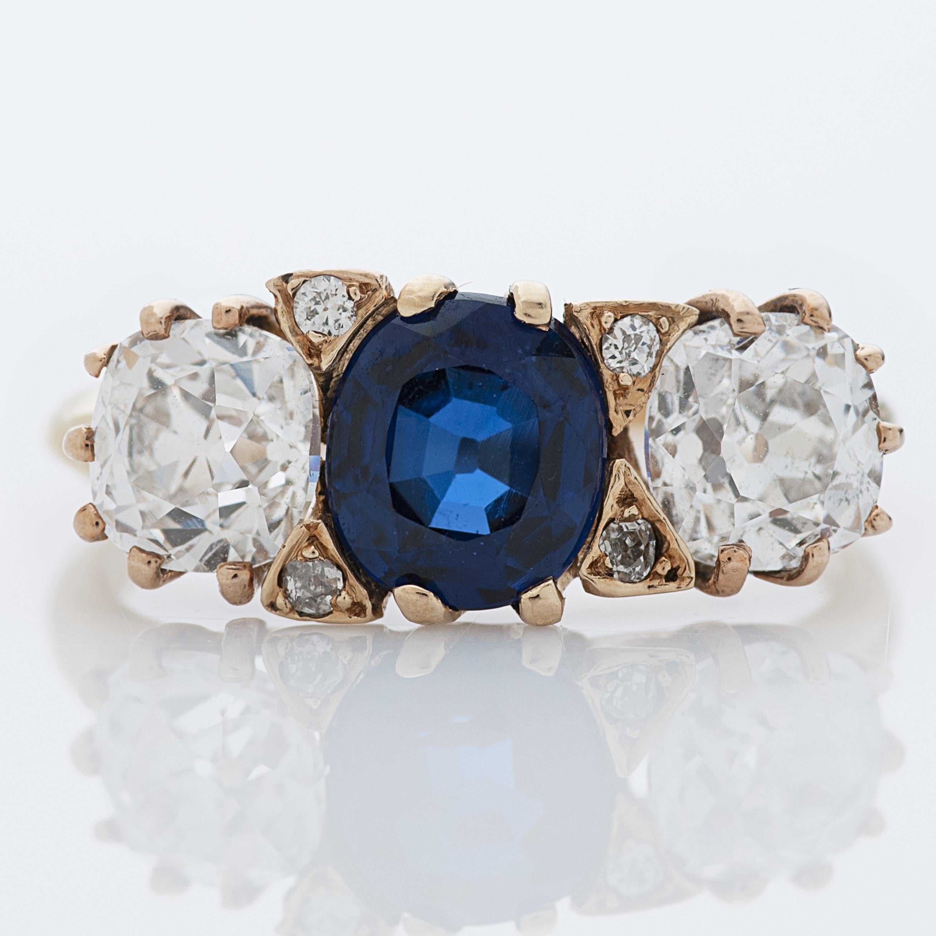 Antique J.E. Caldwell & Co. sapphire and diamond 3 stone ring in 14k yellow gold.

The centerpiece of this ring is a 1.64 carat unheated cushion cut Cambodian sapphire accompanied by an AGL report, with Old Mine Cut diamonds on each side.  One Old