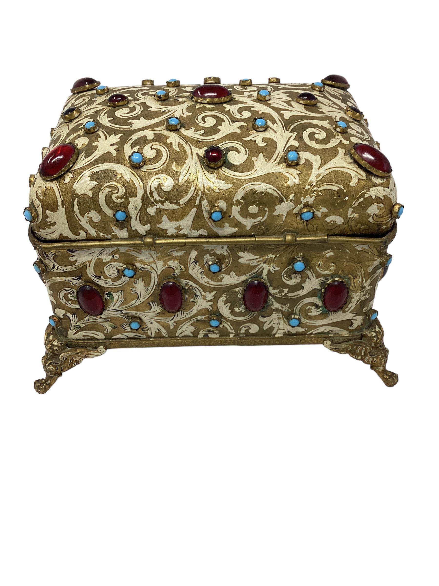 Antique Jewel Encrusted Gilt Bronze Dome Top Box. Gilt bronze box is decorated  enameled finish with and colored cabochon jewels in ruby red and blue glass. The box sits on a winged cat raised on claw feet. Definitely a one of a kind box. The