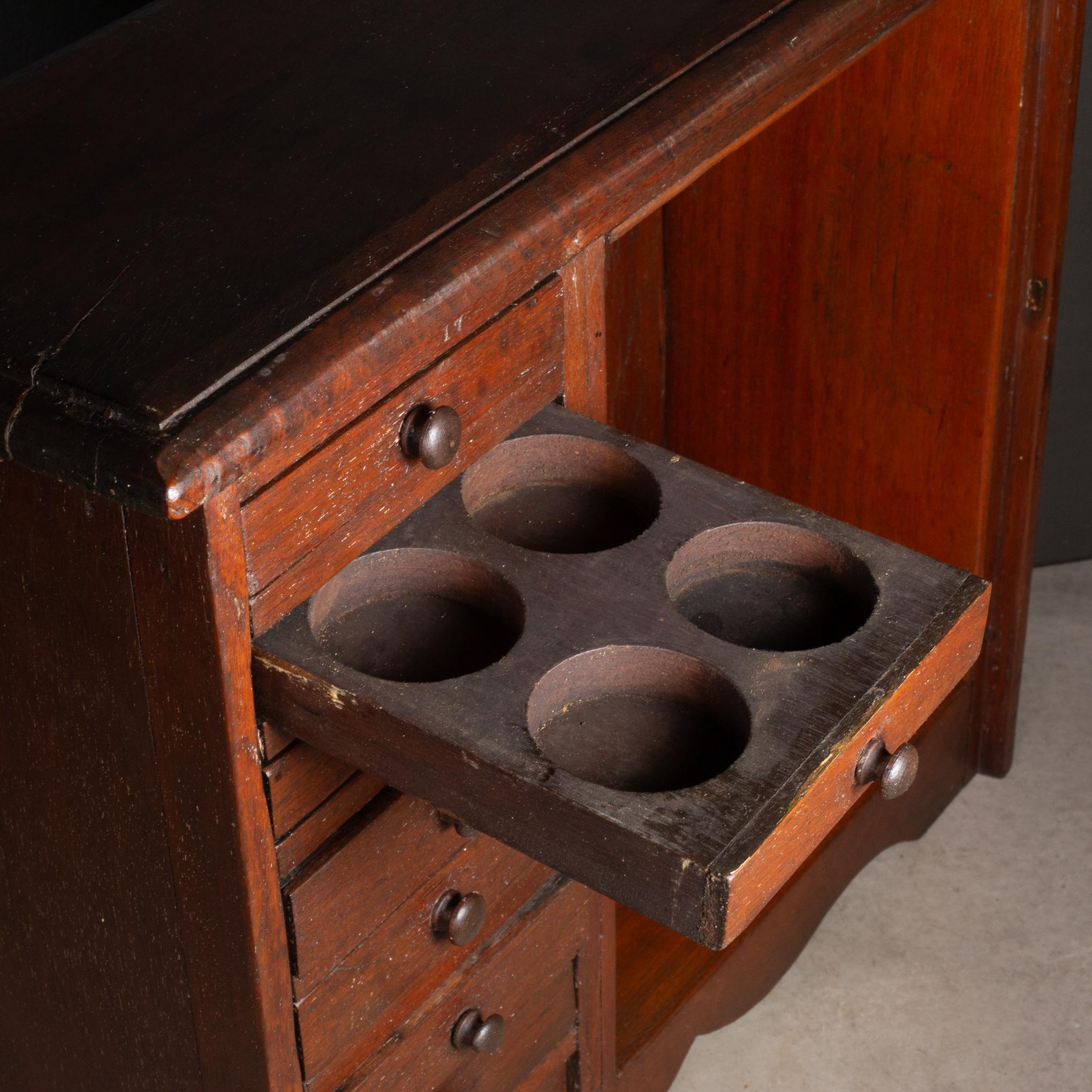 ABOUT

An antique Mahogany jeweler's, watchmaker's cabinet or possibly a lab cabinet for a microscope with seven drawers, inner shelf and round wooden pulls. Top three drawers have four round cutouts each. 

    CREATOR Unknown. 
    DATE OF