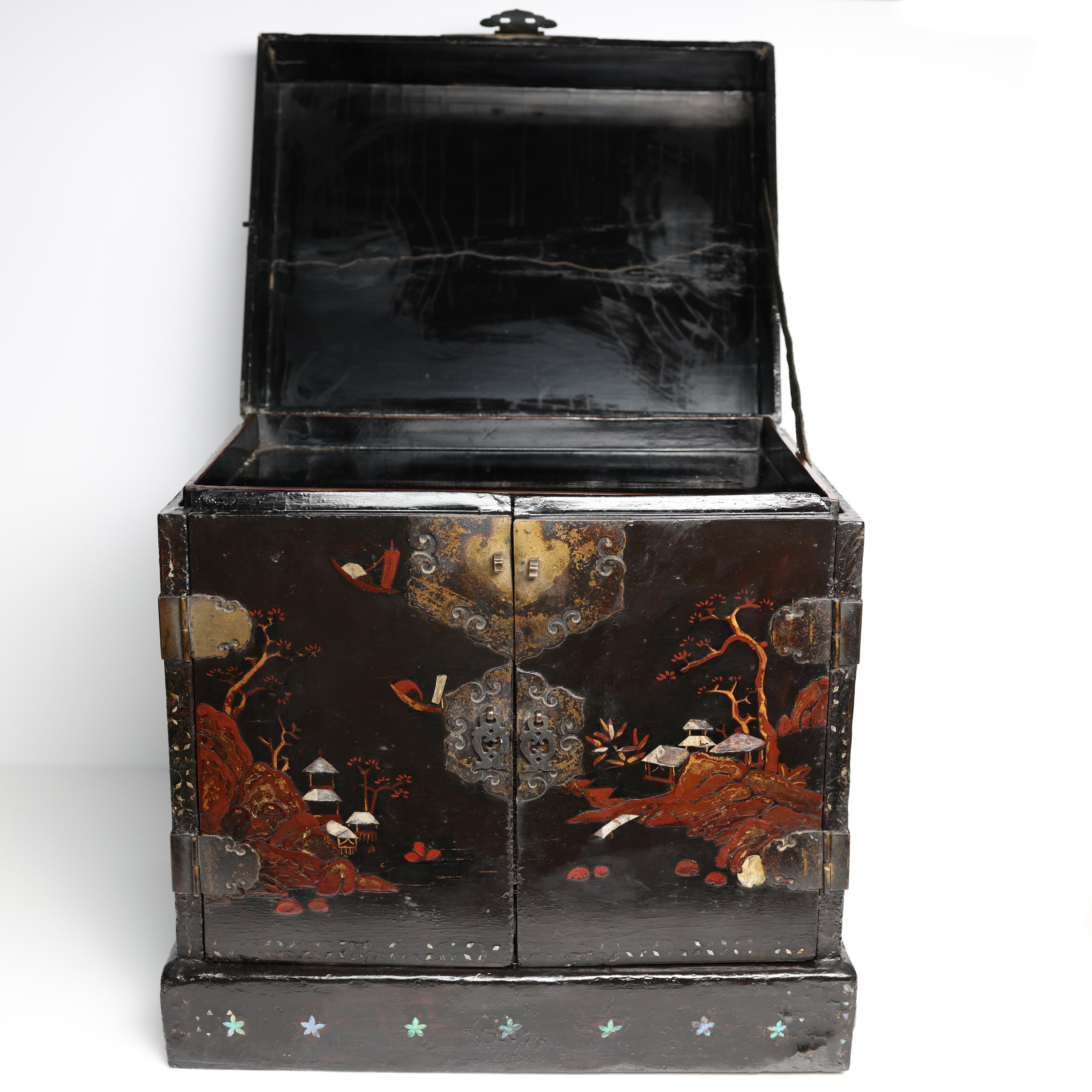 An utterly magnificent and impossibly rare antique jewelry chest from Japan has time-traveled over one hundred years (circa 1900-1920) and arrived relatively unscathed. Thickly painted with inky black lacquer -the dried dap of the Chinese Lacquer