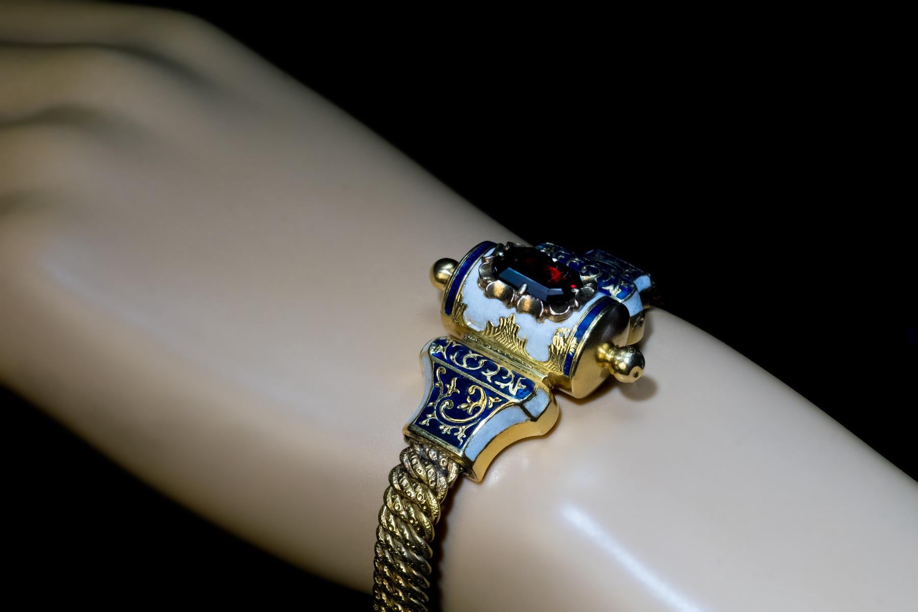 Circa 1860s

This unique, one-of-a-kind 14K gold Jewish bracelet from the 19th century is centered with a garnet-set torah scroll. The bracelet is embellished with cloisonne and guilloche enamel in blue and white colors of Judaism.

Weight is 24.60