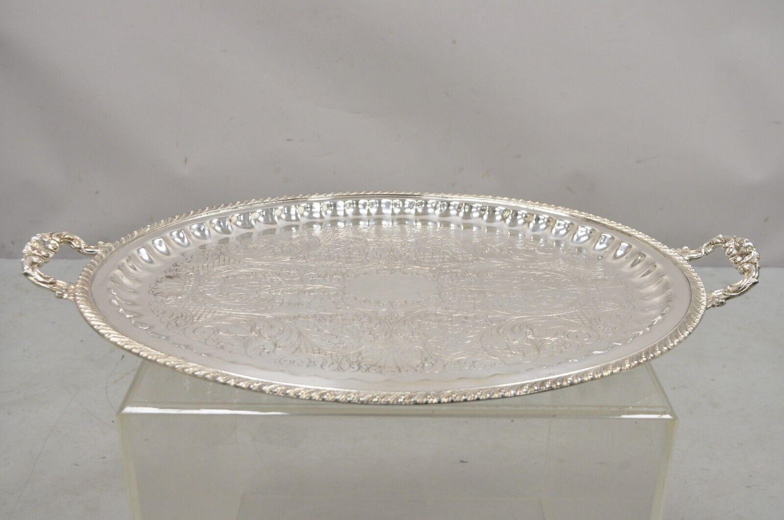 Antique JLS EPC silver plated regency style ornate oval serving platter tray. Item features an oval form, ornate twin handles, scrollwork etched center, original stamp, very nice antique item. Circa early to mid 20th century. Measurements: 2
