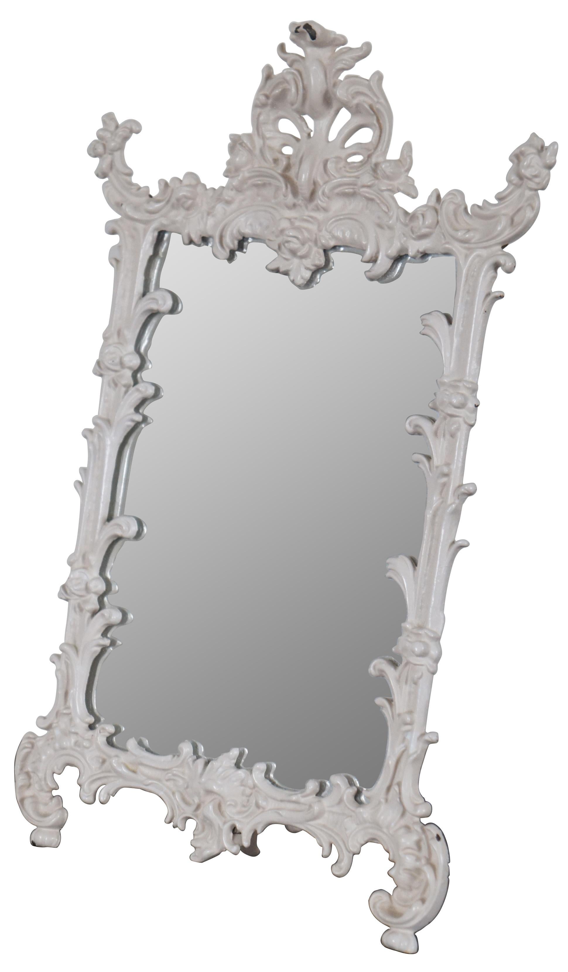 Antique easel style cast iron table top mirror, finished in white with ornate baroque styling, marked “669 JM-38 Iron Art” on the reverse.
 