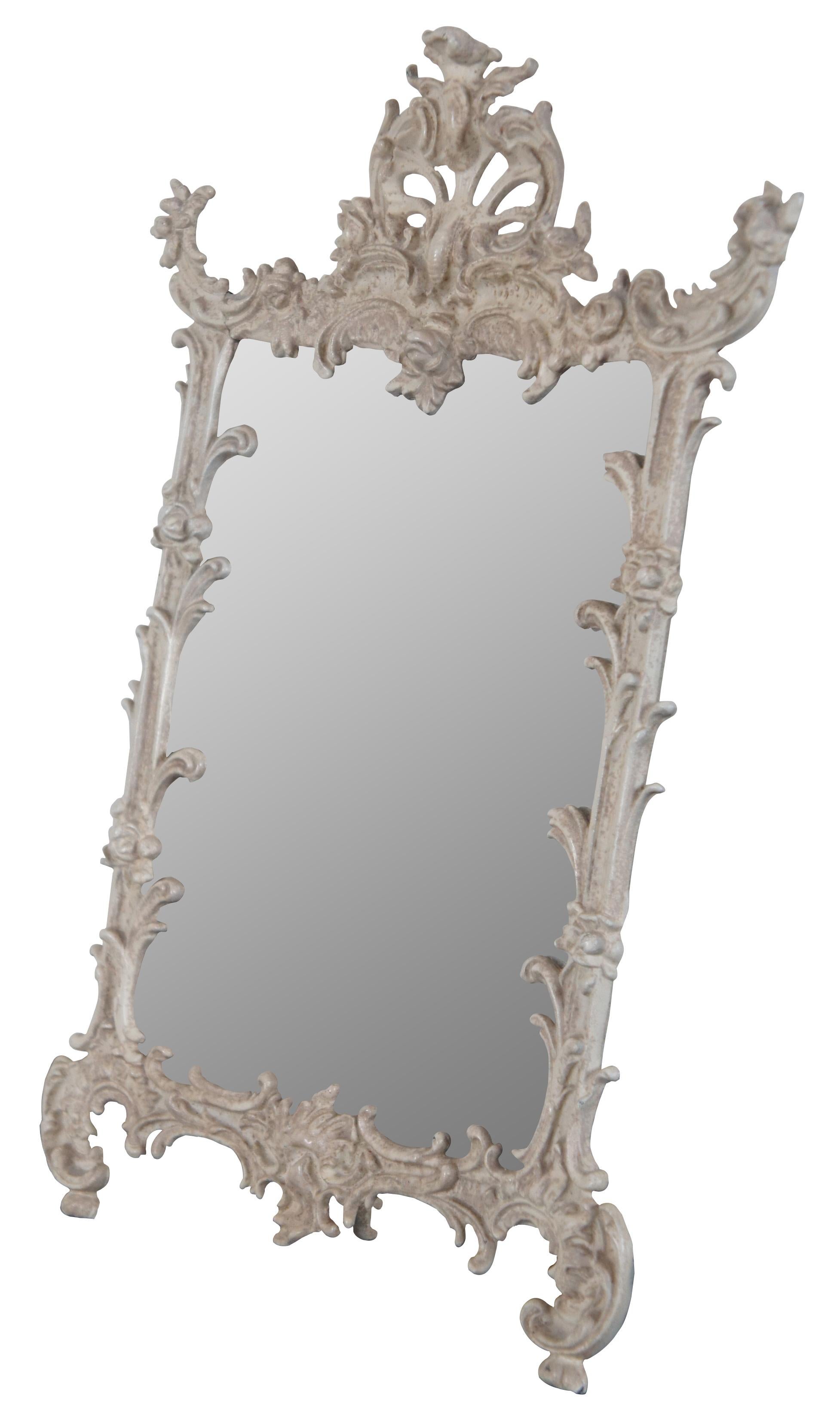 Antique easel style cast iron table top mirror, finished in white with ornate Baroque styling, marked “669 JM-38 Iron Art” on the reverse.

Measures: 9.75” x 3.75” x 15” / mirror - 6.75” x 9.25” (width x depth x height).