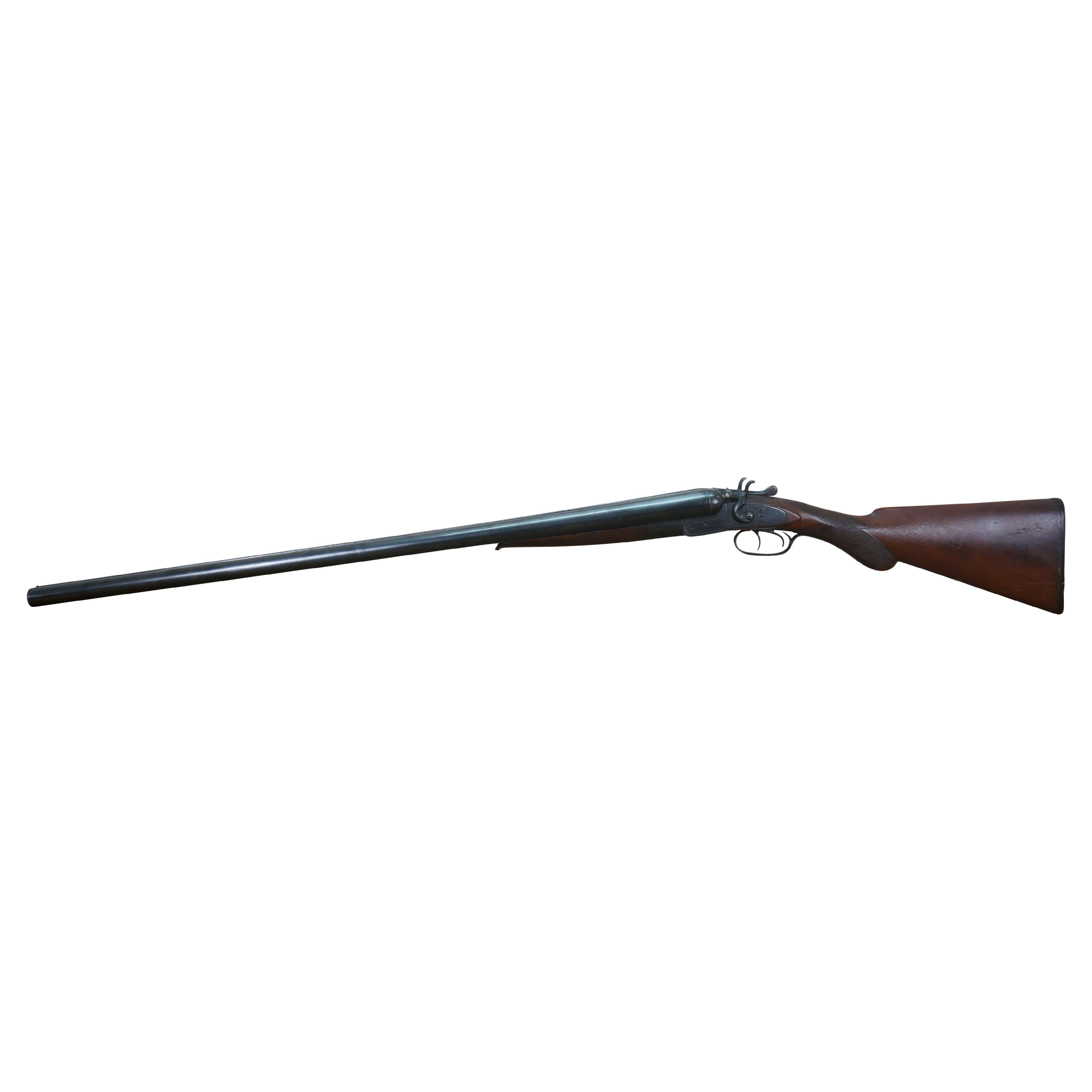 Antique circa 1886 St. Louis J.N. Scott’s double-barrel 12-gauge hammer shotgun. Diamond-carved walnut wood stock and front grip. Sides of frame decoratively etched and read J.N. Scott. Buttplate molded with a hunting dog holding a game bird and a