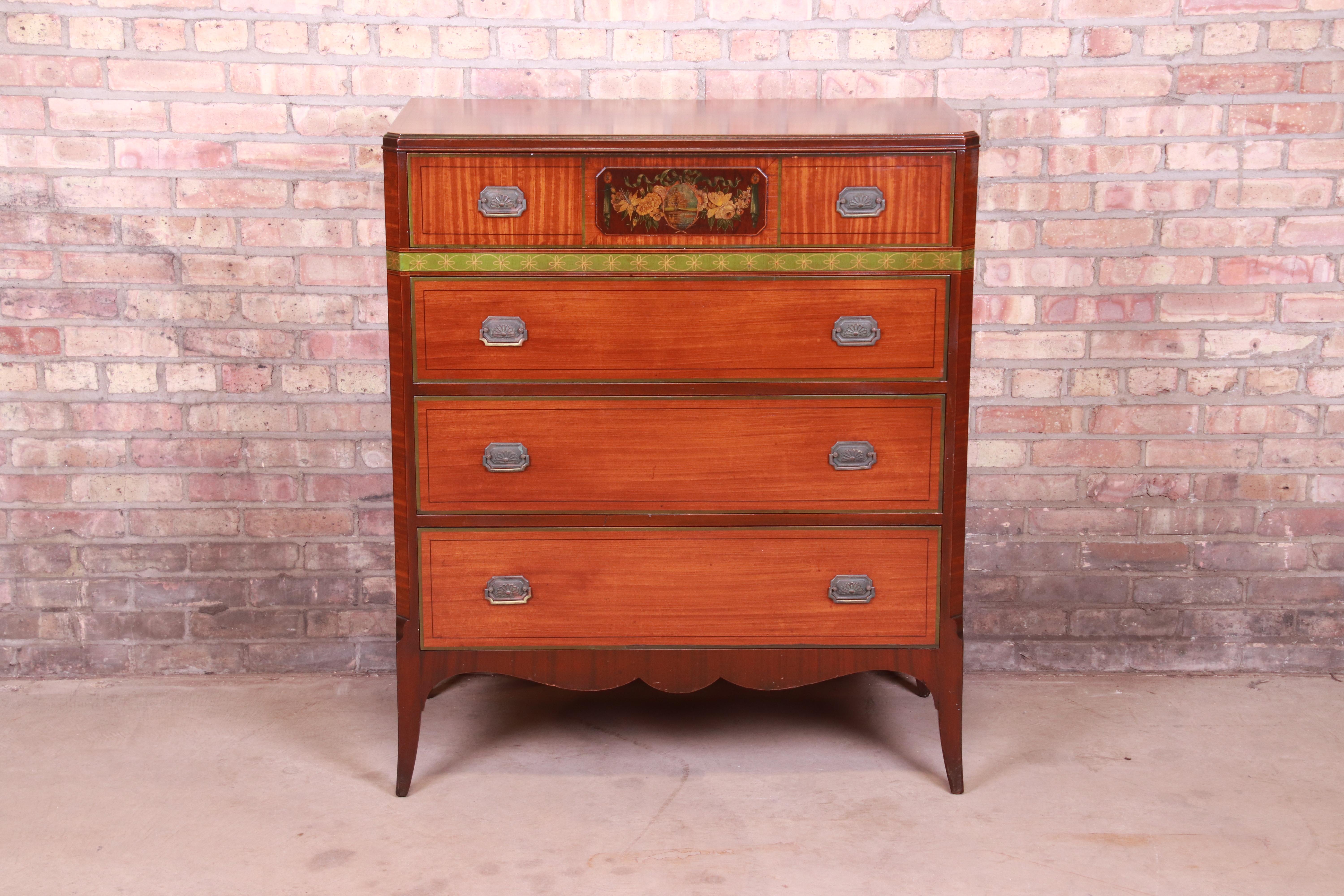 A gorgeous French Provincial style four-drawer highboy dresser

By John Widdicomb

USA, circa 1920s

Mahogany, with hand painted floral details and original brass hardware.

Measures: 38