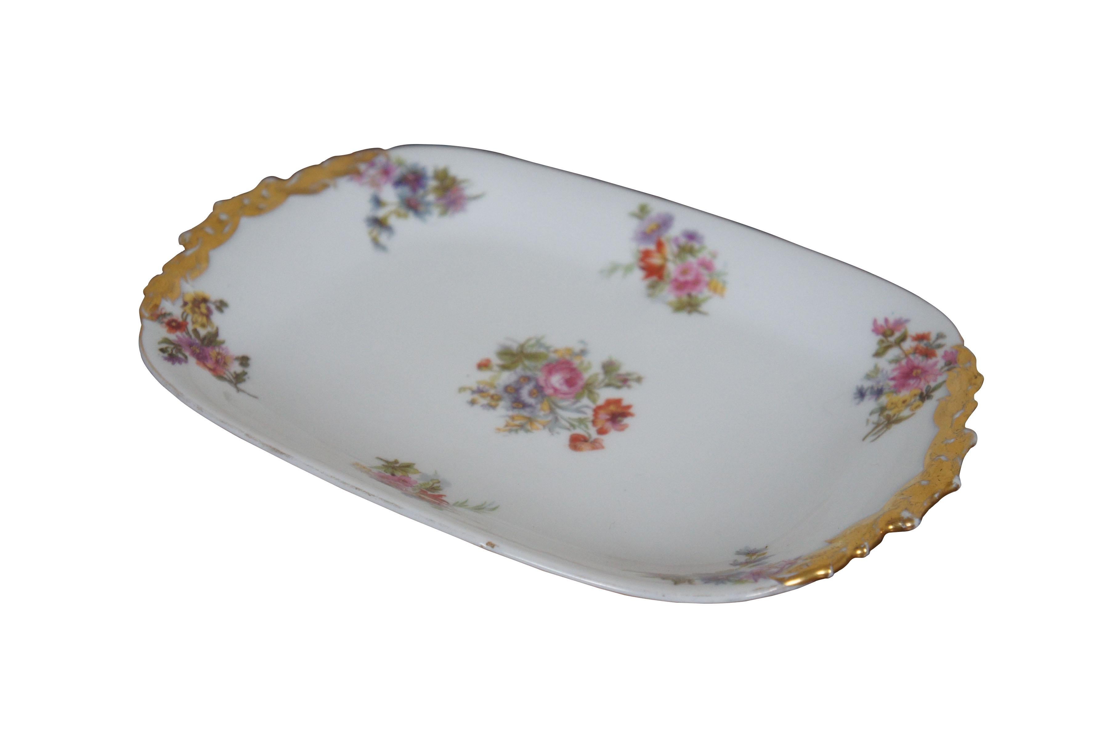 Early 20th century Limoges porcelain serving tray by Jean Pouyat. Rectangular form with gilded hand holds, decorated with litho print floral bouquets.

