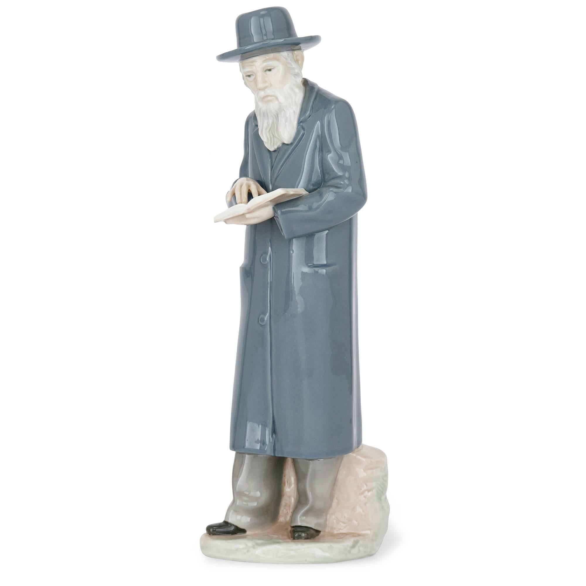 This large antique porcelain figure depicts a Jewish Rabbi with a siddur (prayer book). It is a charming piece of 19th century European porcelain sculptural work, and is a highly collectable decorative piece. Set on a white plinth, the Rabbi is