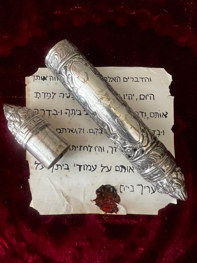 This is an extremely rare and largely decorated late 19th century (ca 1890-1910) sterling silver hand crafted Mezuzah. It’s 14 cm long and in the middle medallion there are masterfully engraved three of the main Judaism’s symbols: David’s star in