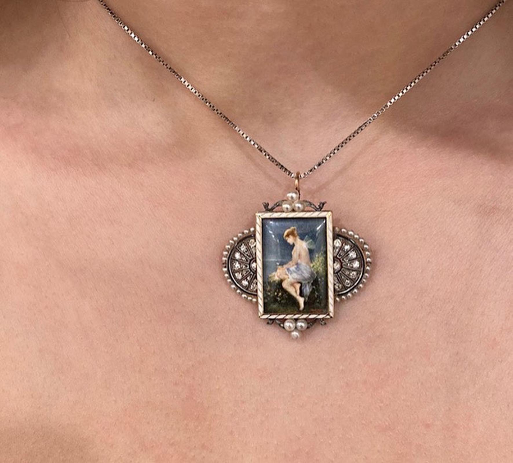 Austria, c. 1910

This delicate antique Jugendstil (Art Nouveau) pendant / brooch features a glazed miniature painting on bone after Wilhelm Kray’s Psyche with a Butterfly on the Seashore. The miniature is set in a white enamel, 14K gold, silver,