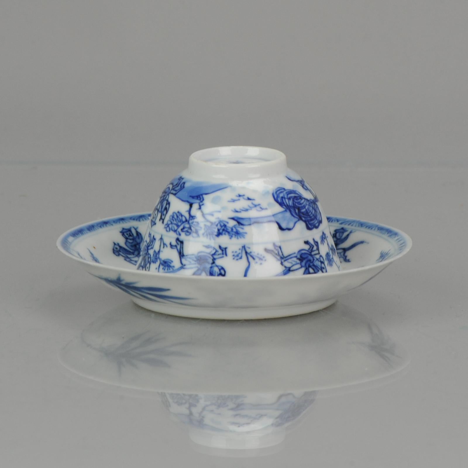 Lovely thinly potted antique Chinese porcelain saucer with a central decoration of a person on horseback next to a tree with a bird in it, executed in a charming underglaze blue. In the border a decoration of patterns identical to those in the
