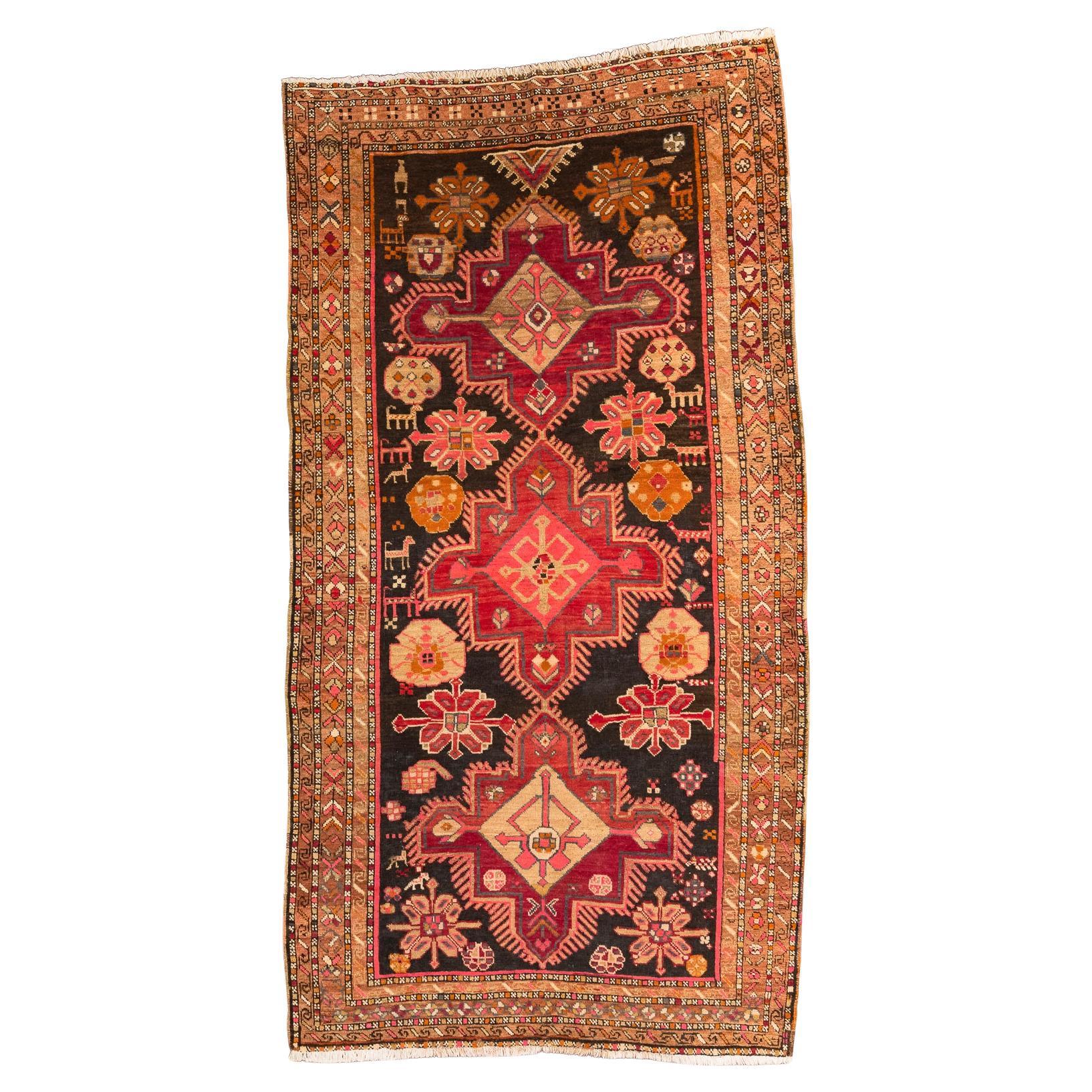 Karabagh – South Caucasus

This cheerful and jovial Karabagh rug features a very traditional design. It presents a lively combination of bold colours that stand out from the rug’s central black field and are accompanied by stylized geometric and