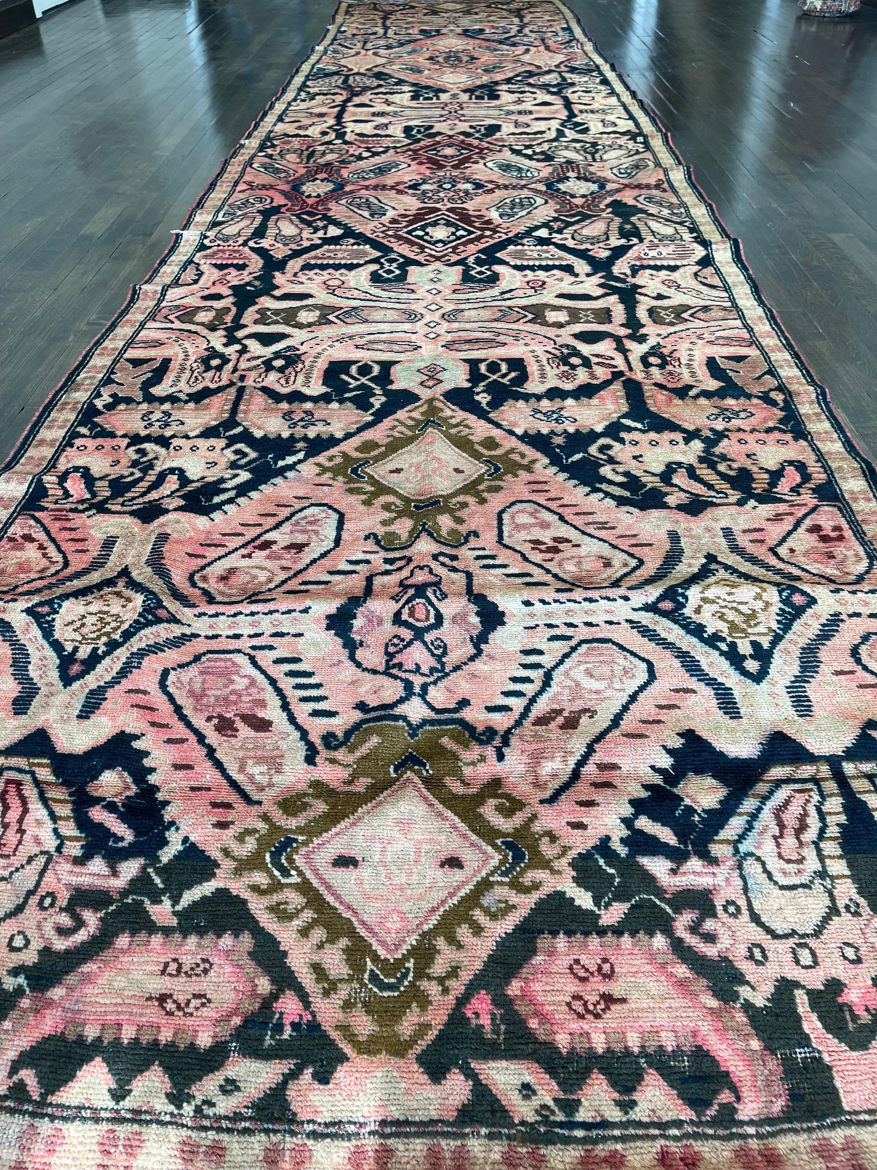 An unusually long Karabagh runner,created in the most southerly of the main caucasian provinces, featuring Dragon motifs on a black field.The rug is decorated with three 