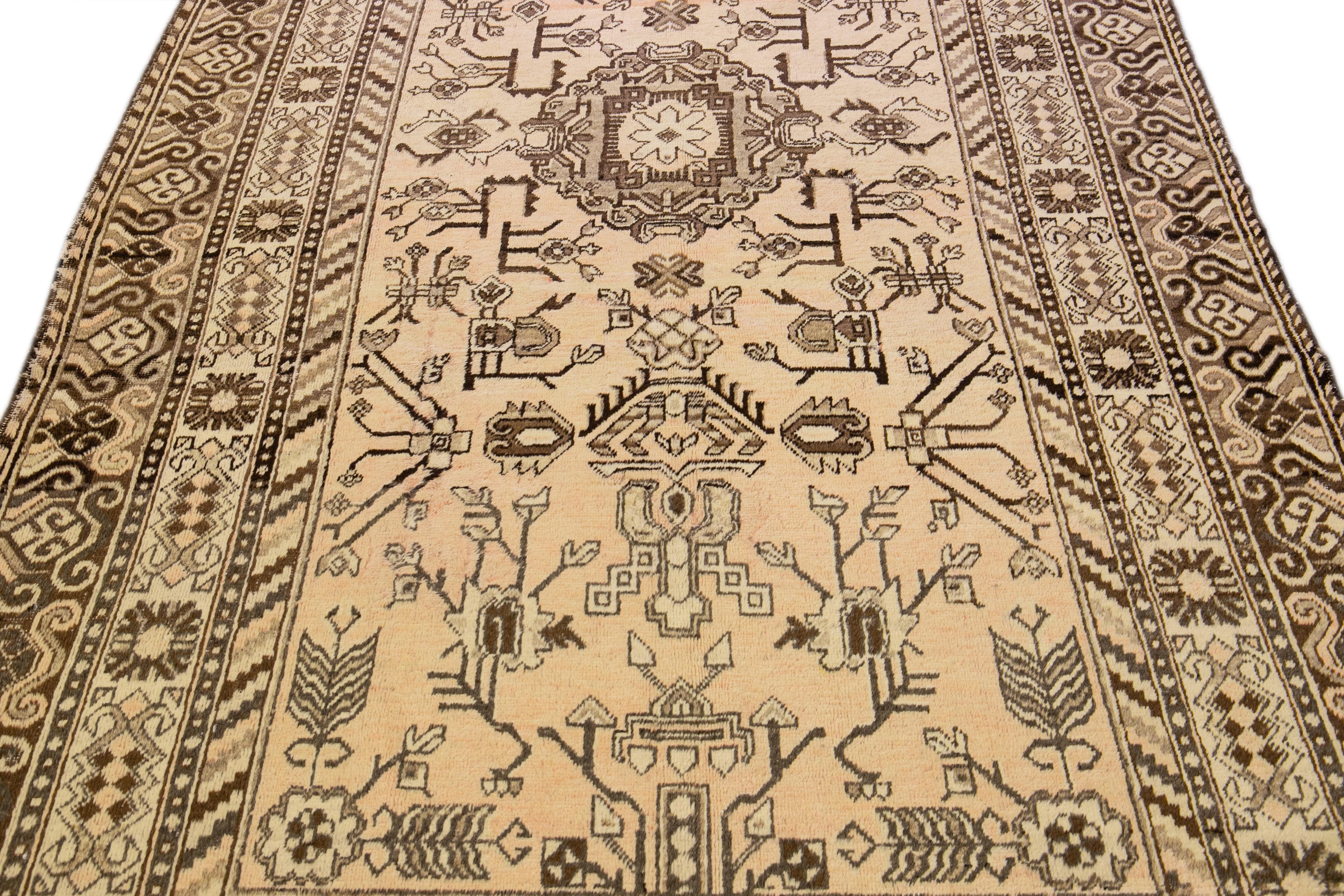 Beautiful antique Karabagh hand-knotted wool rug with beige. This piece has brown accents in an all-over geometric medallion design.

This rug measures: 5'10