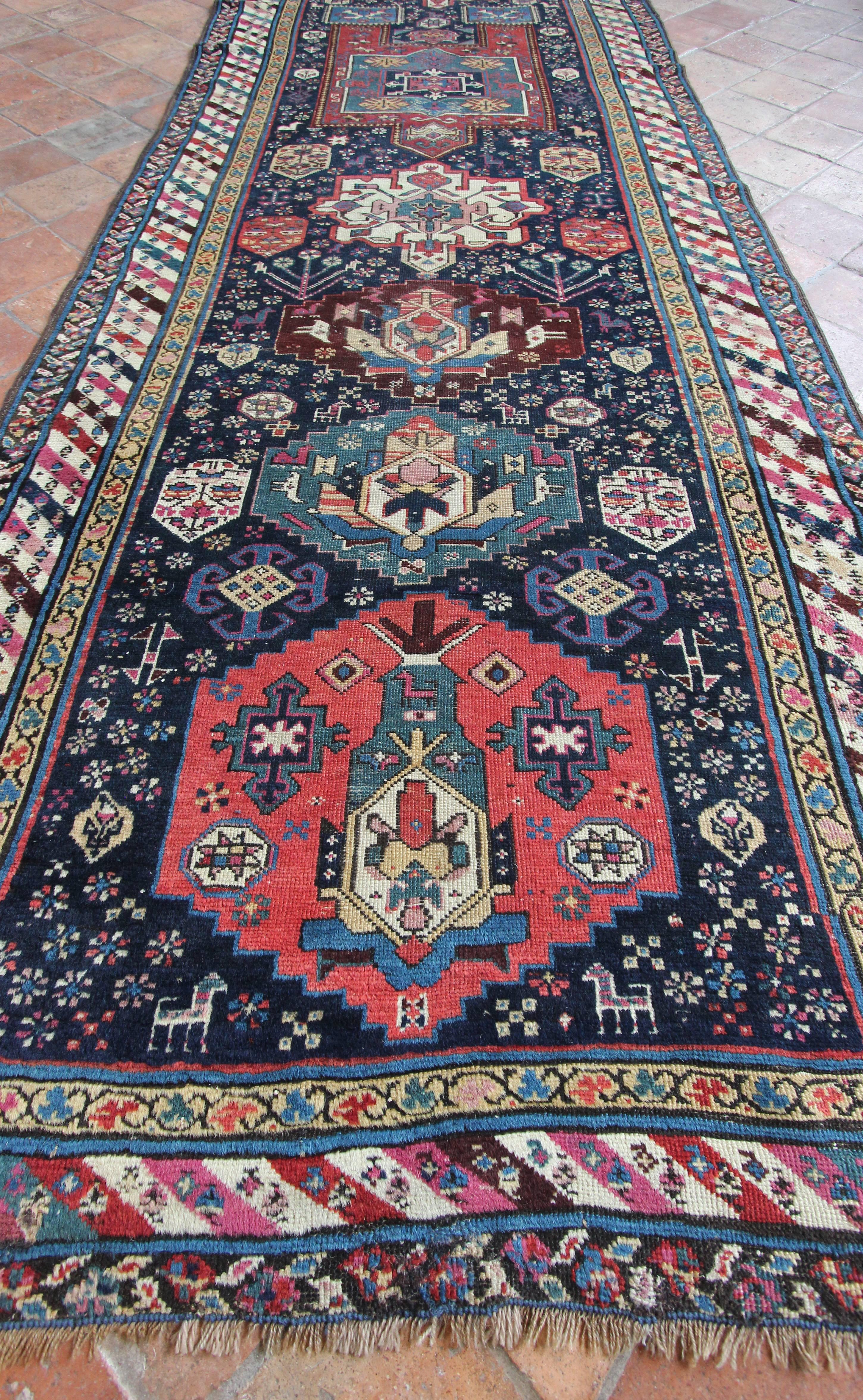 A rare early antique Karabagh runner with outstanding colours and a very interesting design. Woven with bold geometric motifs and an interesting Fachralo style one way design.  The colours are vibrant and saturated with the early dyes we can see