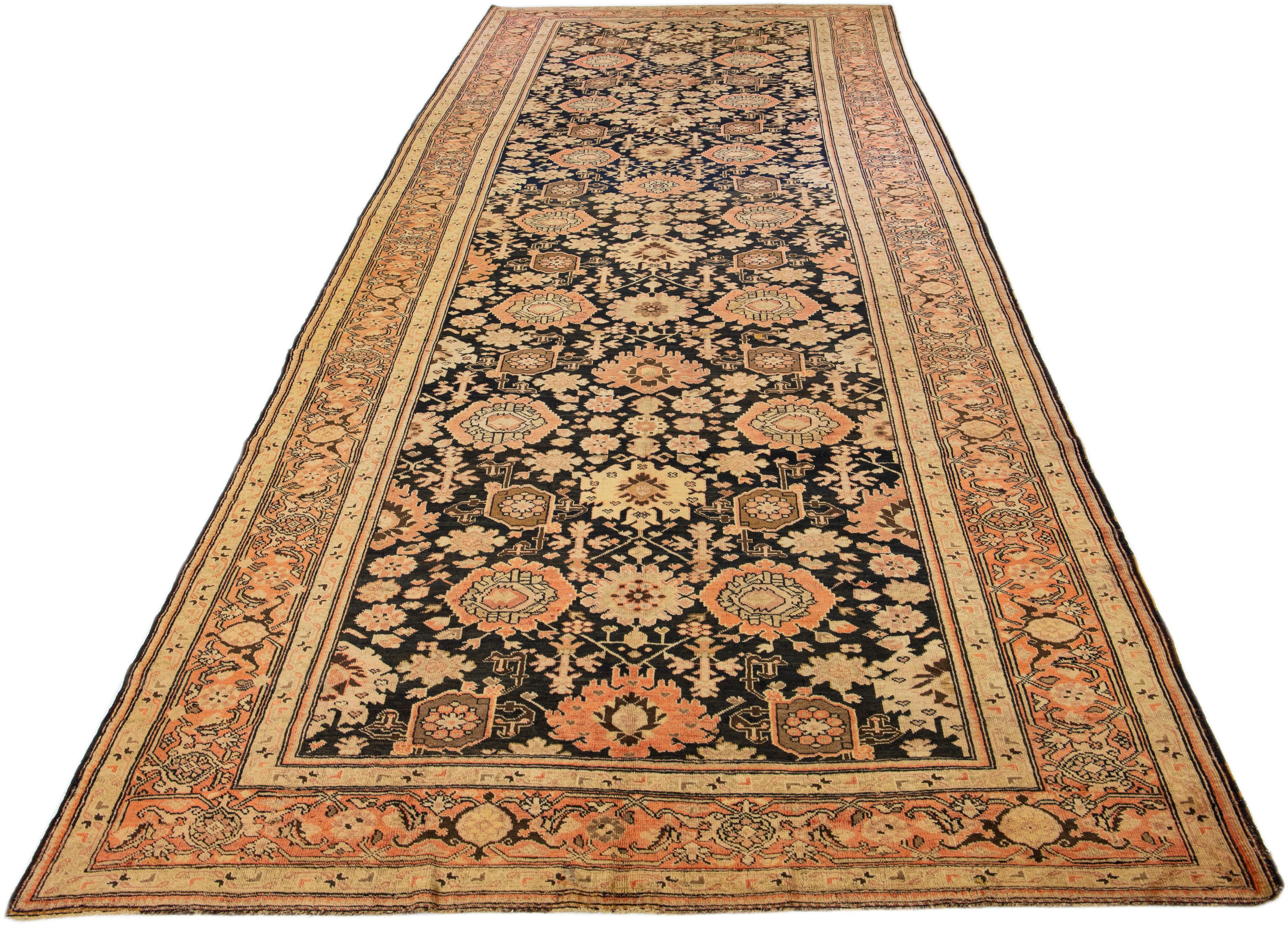 Beautiful antique Turkish Kurd hand-knotted runner with a dark blue color field. This piece has peach and beige accents in an all-over floral design. 

This rug measures 7'2