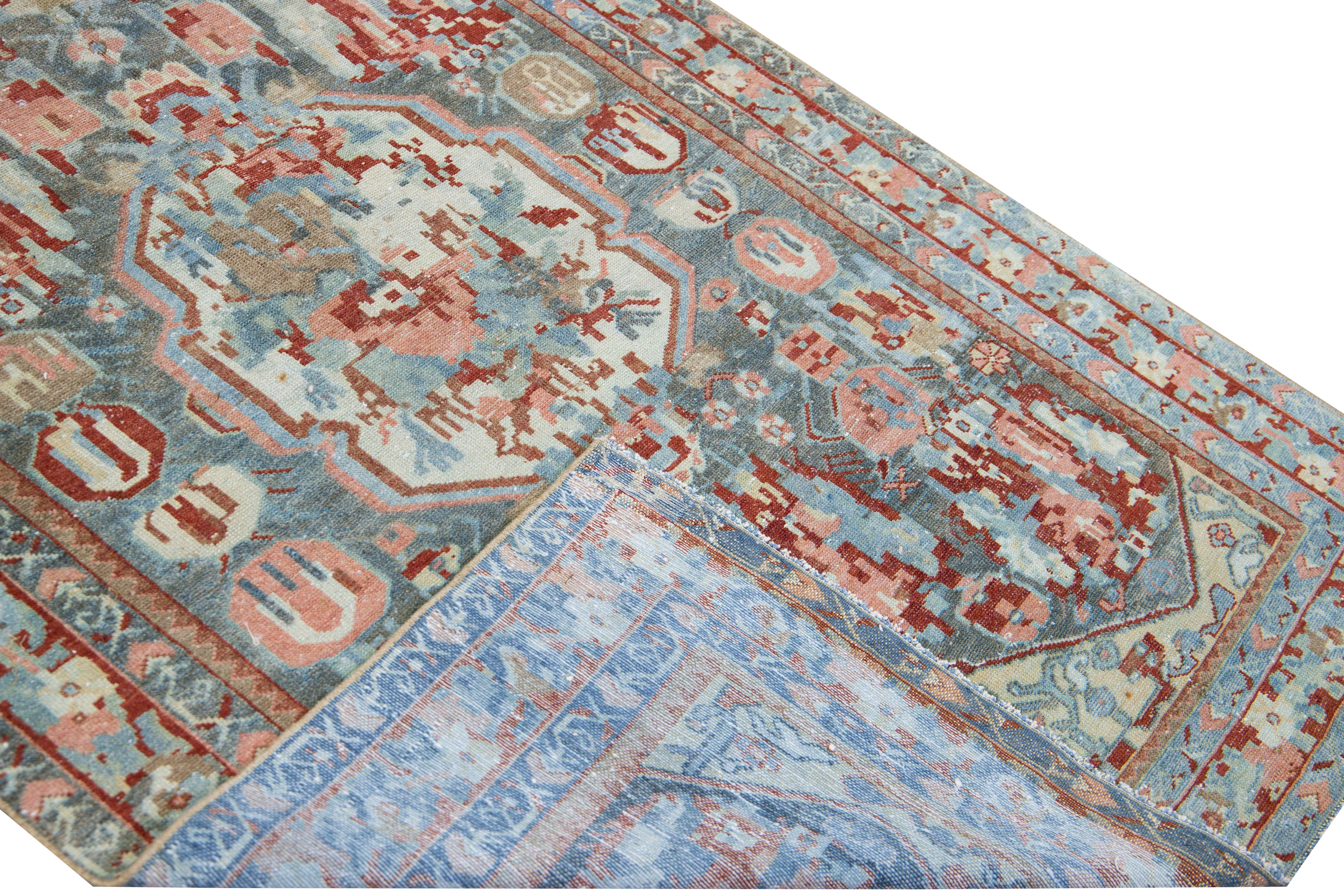Beautiful antique Karabagh hand-knotted wool runner with a blue field. This Persian runner has pink, red, brown, and ivory accents in a gorgeous all-over layout medallion floral motif.

This rug measures 4' x 11' 6
