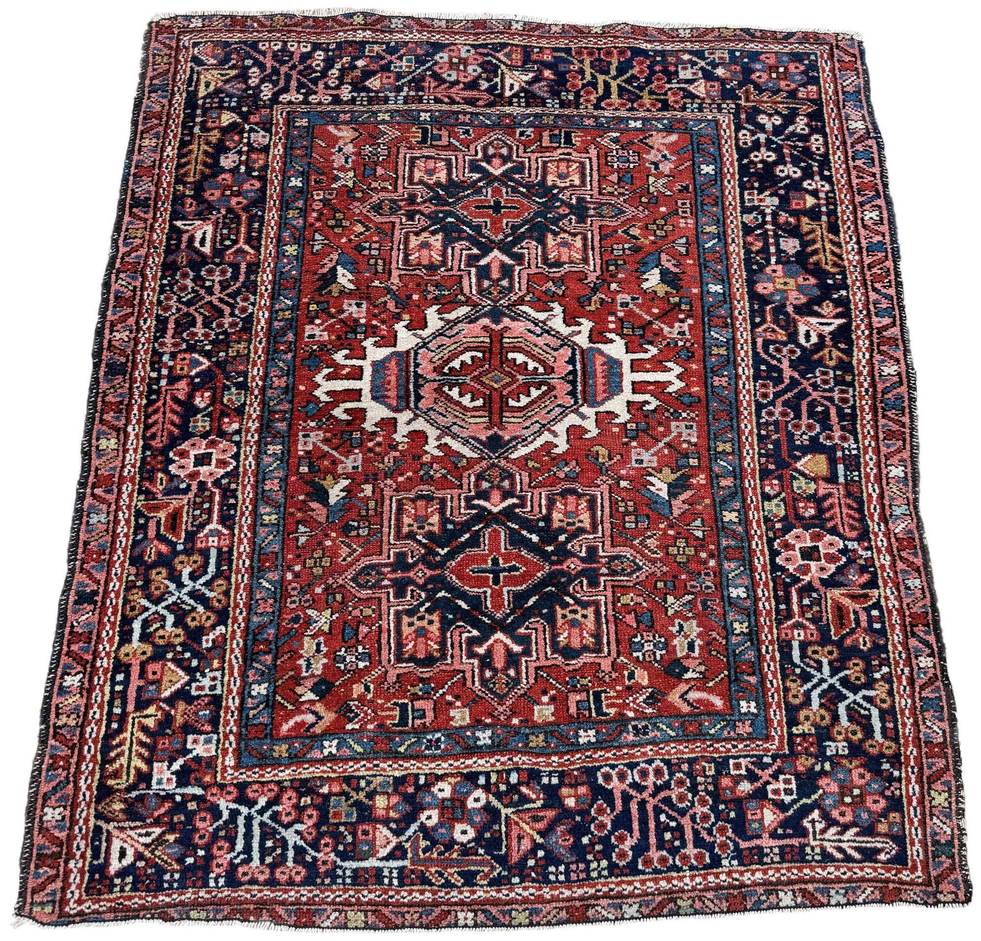 A beautiful antique Karadja rug, woven circa 1920 in an unusual squarish size. This rug features a geometrical 3 medallion design on a rich terracotta field and deep indigo border. Some great secondary colours including a soft pink and light blue,